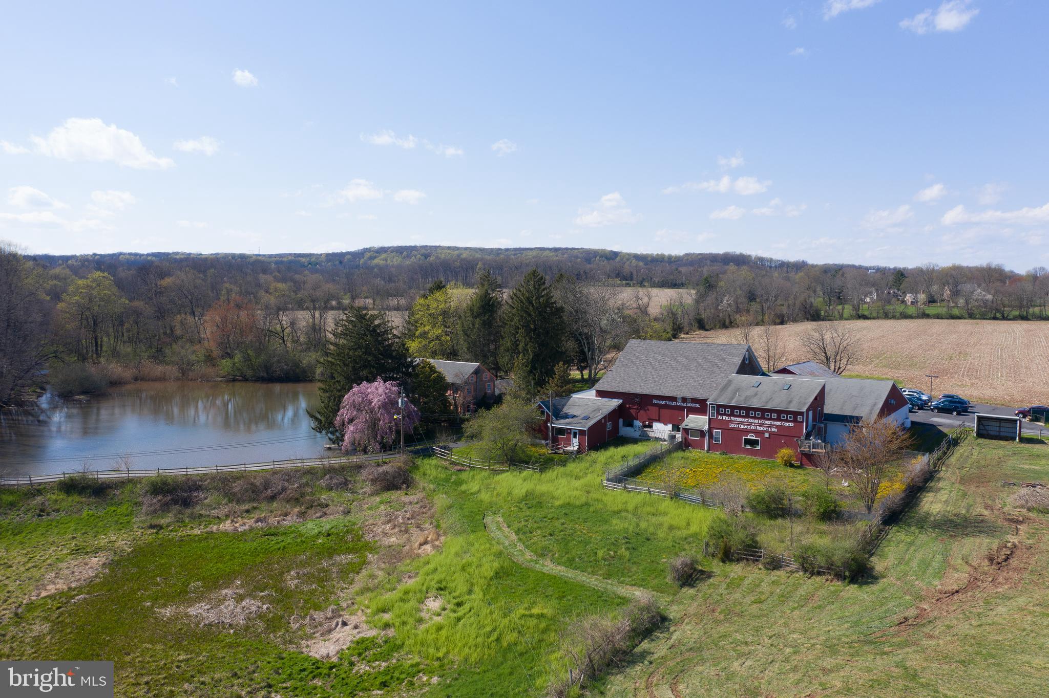 This BUCKS COUNTY FARM offers so much OPPORTUNITY. This is the first time that this exceptional multi-use property has been available for sale in many, many years. The individual components of this property offer tremendous residential, agricultural and investment value - the aggregate creates a once-in a-lifetime opportunity for the new owner. THE LAND: There are 49+ acres featuring Open Fields (currently used for Agriculture Production); a Stream-fed Pond with Dock; Wooded areas; Landscaped Yards with flower beds and trees, and Open Pasture areas. THE HOME: At the heart of this property, you ll find the classic 19th Century Stone Farm House featuring a Newer Addition with an open dining area and great room, central air conditioning throughout, and a living room with high Stone Fireplace. A large Master Bedroom Suite offers panoramic Waterfront Views of the pond. THE RENTAL INCOME: The on-site veterinarian practice has a long term lease, offering the investor Immediate Cash Flow and Return on Investment. THE BARN & OUTBUILDINGS: So much possibility with lots of storage - bring your hobbies and creative vision. THE LOCATION: The pastoral Springfield Township community of Pleasant Valley offers direct, easy access to the Lehigh Valley, Rt 78, Rt 309 and the PA Turnpike. Experience what is now, imagine what will be - Schedule your private tour today.