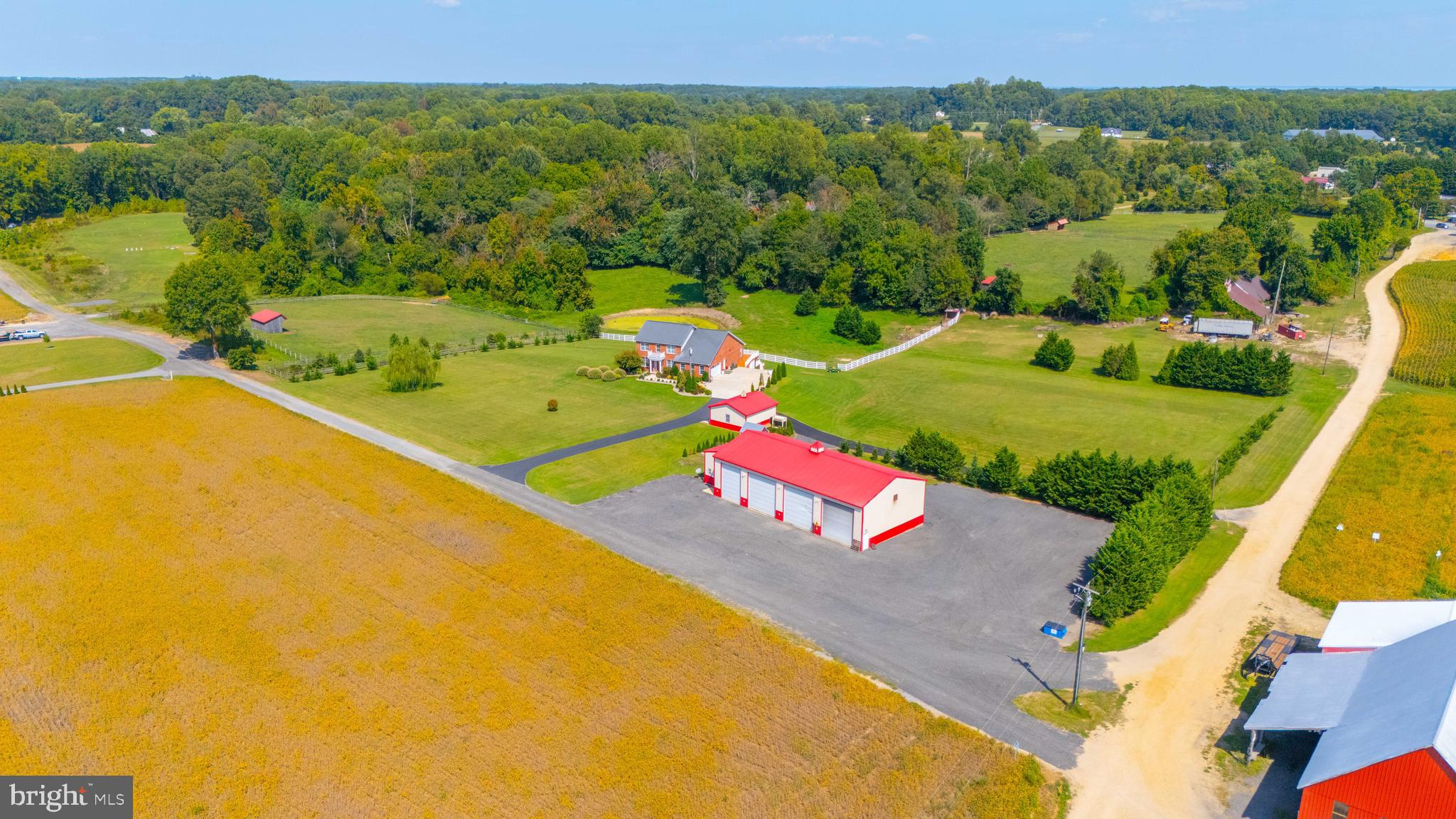 This exquisite custom-built all-brick home is situated on nearly 3 acres with stunning views of expansive farmland. The property boasts a wealth of features, including a 40'x80' 4-bay garage building with a pit, 20' ceilings, insulated doors, heating/air conditioning, an office with a loft, and a full bath. There is also an additional detached 2-car garage. The home offers an open floor plan with 9' ceilings, an upgraded kitchen featuring granite countertops, a gas stove, a wall oven, a microwave, and hardwood floors throughout. The bright and open family room and dining area provide a welcoming atmosphere. The primary bedroom is conveniently located on the main level and includes a luxurious bath with a tile shower and soaking tub, along with another guest bedroom and full bath. The upper level consists of 3 additional bedrooms and a full bath. The lower level is perfect for long-term guests, featuring a fully equipped kitchen, a great room, 2 bedrooms, a full bath, a sitting room, and more. The home also includes its own 2-car garage.
This property is a must-see to truly appreciate all it has to offer. With quick access to Washington D.C., AFB, Annapolis, and the Naval Academy, it's perfectly situated for convenience and comfort.