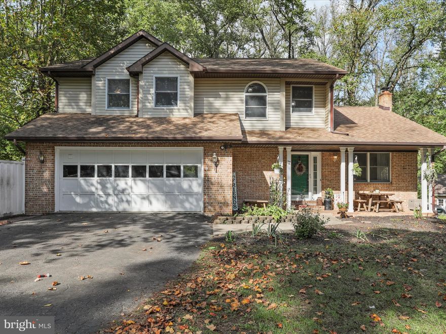 Discover this gem in Woodbrier Manor. This updated 3 bedroom, 2.5 bath home sits on a corner half-acre lot just a short walk from Woodbrier Golf Course. Inside, you’ll love the bright country kitchen with breakfast bar, the spacious living room with cathedral ceiling, and the cozy office/playroom featuring a wood-burning fireplace. French doors from multiple rooms open onto a private rear deck overlooking a picturesque yard with mature trees—ideal for relaxing or entertaining. The primary suite is a true retreat, featuring a wood-burning fireplace, cathedral ceiling, walk-in closet, private bath, and enough space to create an additional room if desired. Recent updates include new laminate plank flooring throughout (2025), a new heat pump (2024), and refreshed bathrooms with new toilets and vanities.  A welcoming front porch, main-level laundry, unfinished basement, 2-car garage, and shed complete the package. Move-in ready, beautifully updated, and loaded with character—12 Shadow Lane is more than a house, it’s the home you’ve been looking for!