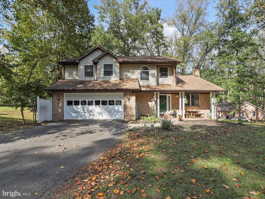 Welcome to 12 Shadow Lane — where charm, comfort, and convenience meet.

Situated on a beautifully landscaped half-acre corner lot in desirable Woodbrier Manor, this updated 3-bedroom, 2.5-bath home delivers space, style, and a lifestyle you’ll love. Just a short walk from Woodbrier Golf Course, it’s perfectly positioned for peaceful living with easy access to everything you need.

Step inside to a bright country kitchen with a breakfast bar, a soaring-ceiling living room filled with natural light, and a flexible office/playroom anchored by a cozy wood-burning fireplace. Exit through any of the French doors and discover the home’s hidden sanctuary — a large deck overlooking a storybook backyard with mature trees and seasonal color. — the perfect backdrop for morning coffee or evening gatherings.

The primary suite is a standout: a vaulted retreat with its own fireplace, walk-in closet, private bath, and enough space to create a reading nook, workout corner, or even a nursery.

Recent upgrades include laminate plank flooring (2025), a new heat pump (2024), and refreshed bathrooms. With a welcoming front porch, main-level laundry, 2-car garage, unfinished basement, and backyard shed, this move-in-ready home checks all the boxes.

Warm, inviting, and full of character — 12 Shadow Lane is the one you don’t want to miss.
