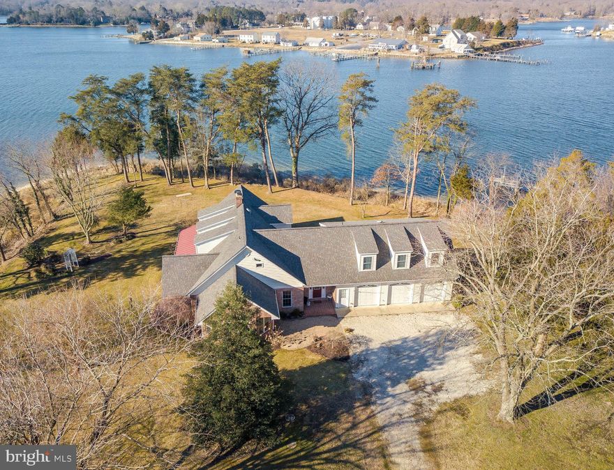 WOW!!!!!  This is it.  A Waterfront Property with an Incredible View from 3 sides of the Home.  Pier with Boat Lift, small beach area, beautiful sun rises and sunsets.  Almost 2 acres with Privacy, nature and just the neverending beautiful Views.  Home features first floor Master Suite with view, First Floor Laundry Room,  Another First Floor Bedroom, Upgraded Kitchen  that features  large Pantry, island, granite countertops, recessed lighting, Breakfast Nook with a view,.  Hardwood Floors throughout the first floor, Oversized Garage with  a Bonus Room Above with Separate Entrance, Kitchenette and private Bath.  Additional 2 Bedrooms on 2nd floor and 3rd room for office/playroom/theater room, etc.  Utility Room  with storage, Generator, AND Sooo Much More!  Don't Miss out on this one.