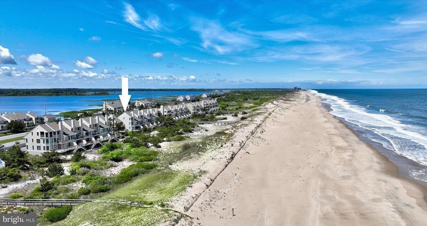 Stunning Oceanfront townhome that was meticulously renovated, expanding the great room on the beachside with a wall of glass along the ocean and a large window to the south, bringing in an abundance of natural light and unparalleled views of the Atlantic!   This unique property feels and lives like an end unit because it is positioned further East when compared to the adjacent unit and building to the South. This exquisite property was renovated from top to bottom with fine finishes and features including a timeless kitchen with crisp white cabinetry, stainless steel appliances and quartz counters.  The kitchen and great room spill onto an oceanfront deck, creating the ideal layout for entertaining at the beach.  Also on the main level is the first of five bedrooms and a beautifully updated full bathroom.  Step upstairs to the oceanfront primary suite with expansive views of the beach both inside and out.  This room offers a private balcony overlooking the ocean and a dream coastal bathroom with an expertly designed glass and tiled shower with ocean views. Also on this floor is an additional bedroom with peaks of the bay where you can catch captivating sunsets and an updated private bathroom.  Laundry is also on this level.  The third floor features a second oceanfront bedroom with stunning views of the coastline, another beautifully tiled full bathroom and the fifth bedroom.  Enjoy breathtaking sunrises over the Ocean or watch the sunset over the bay from nearly every room in this special property.  The conveniently covered ground level provides an outside shower, storage room for your beach necessities, and an electric vehicle charger under the walkway.  Kings Grant offers a community swimming pool and pier for fishing, crabbing, and kayak launching.