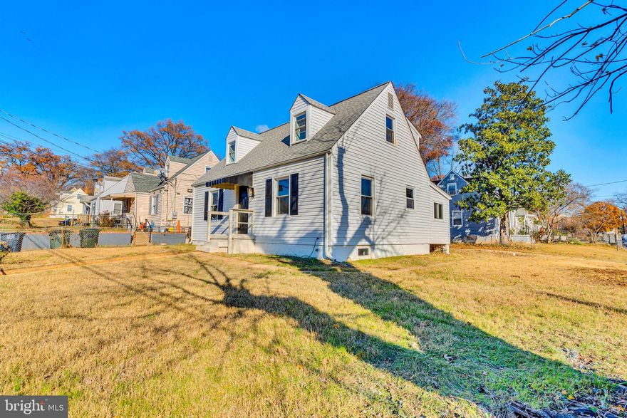 Fully renovated Cape Cod with main level Sunroom Addition, plus a raised roof addition on the upper level. All new modern kitchen. All 3 bathrooms are new. New HVAC & Furnace System. New Hot Water Heater. New roof and vinyl siding. New flooring. New light fixtures, plus much much more. Come and experience modern upgrades blended with timeless charm. The home features hardwood floors and recessed LED lighting throughout, creating a bright and inviting atmosphere. The spacious living room flows seamlessly into the all-new kitchen, which boasts granite countertops, brand-new appliances (including a gas stove, dishwasher, refrigerator, and built-in microwave), upgraded cabinets, and LED recessed lights. Just off the kitchen is a versatile 18’ x 6’ Sunroom addition, perfect as a family room or dining area, with direct access to the back deck. The main level includes two well-appointed bedrooms and a fully renovated hall bathroom with designer tile, a new vanity, updated lighting, and a new toilet.
Wooden stairs with white risers lead to the upper level, which features two spacious bedrooms with hardwood floors, recessed lighting, and updated closet doors. A fully renovated hall bathroom includes a step-in shower with designer tile surround, built-ins for convenience, a raised vanity, and decorative lighting. The finished basement offers a large recreation room with LPV flooring, recessed lighting, and a separate fifth bedroom. The third full bathroom in the basement has been completely updated with designer tile finishes, a new vanity, lighting, and a shower. A separate basement exit door provides access to the backyard. The exterior of the home is as impressive as the interior, with a brand-new roof and siding, both wrapped for a maintenance-free finish. A chain-link fence secures the front yard, while a concrete driveway offers convenient parking in the back. Don't miss the opportunity to make it yours!