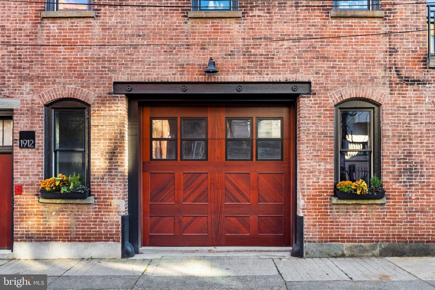 Welcome to 1914 Wilcox Street—a residence unlike anything else in Philadelphia. This 44-foot wide, stand-alone carriage home combines historic character with contemporary luxury, offering a scale and presence rarely found in the city.

Spanning roughly 3000 square feet, this home feels expansive at every turn, with light-drenched interiors and a seamless open layout. Featuring 4 bedrooms, 4 bathrooms, and an oversized garage crowned with the iconic carriage house door, every detail has been carefully curated for both elegance and comfort.

First Floor
Enter through a striking foyer adorned with large-format tiles imported from Spain and Italy. This level offers two spacious bedrooms and two full bathrooms, creating an ideal setup for private guest suites or flexible work-from-home spaces.

Second Floor
Ascend the custom spiral staircase to the dramatic centerpiece of the home. At its heart is a 25-foot wide gourmet kitchen, designed with two-tone cabinetry, paneled appliances, a quartz slab backsplash, an integrated range hood, immense storage, and an oversized waterfall island that invites gathering. The adjoining dining area is set in front of the home’s historic hay loft doors—a design element that serves as a daily reminder of the home’s rich history.

The living room on this level is both stylish and comfortable, anchored by a striking glass wine display and offering a warm, welcoming space for relaxation or entertaining. A full bedroom with a hall bathroom completes this floor, ideal as a guest room or dedicated home office.

Third Floor
The entire top floor is dedicated to the primary suite, a private sanctuary above the city. Here, soaring ceilings and natural light create an airy retreat. The spa-inspired ensuite features a bespoke glass-enclosed two-person shower, large fluted tiled walls, and a sculptural freestanding tub, blending luxury and tranquility. Custom walk-in closets provide exceptional storage, while direct access to a private terrace offers an intimate outdoor escape for morning coffee or evening relaxation.

Outdoor Living & Beyond
Crowning the home is a rooftop oasis with two dedicated areas, perfect for a combination of lounging and dining. Here you’ll enjoy 360-degree views of Philadelphia, allowing you to take in both sunrise and sunset from the comfort of your own home.

Practical luxuries abound: an oversized 1-car garage parking (room for storage), white oak flooring throughout, and meticulous craftsmanship at every turn. From Anderson windows to custom millwork, no detail has been overlooked.

Location & Lifestyle
Live in the heart of Spring Garden, where convenience meets culture. Enjoy close proximity to the Center City business district, with easy access to the city’s thoroughfares for seamless commuting. Stroll to Whole Foods, explore the Museum District, or take in the fresh air and open space of the Benjamin Franklin Parkway. Here, every amenity and attraction of Philadelphia is just steps from your door.

This Carriage House is more than a home—it’s a statement. With its unmatched 44-foot width, iconic architecture, and modern luxury, 1914 Wilcox sets a new standard for Philadelphia living and you'll benefit from a 10-year tax abatement. Schedule your private showing today.
