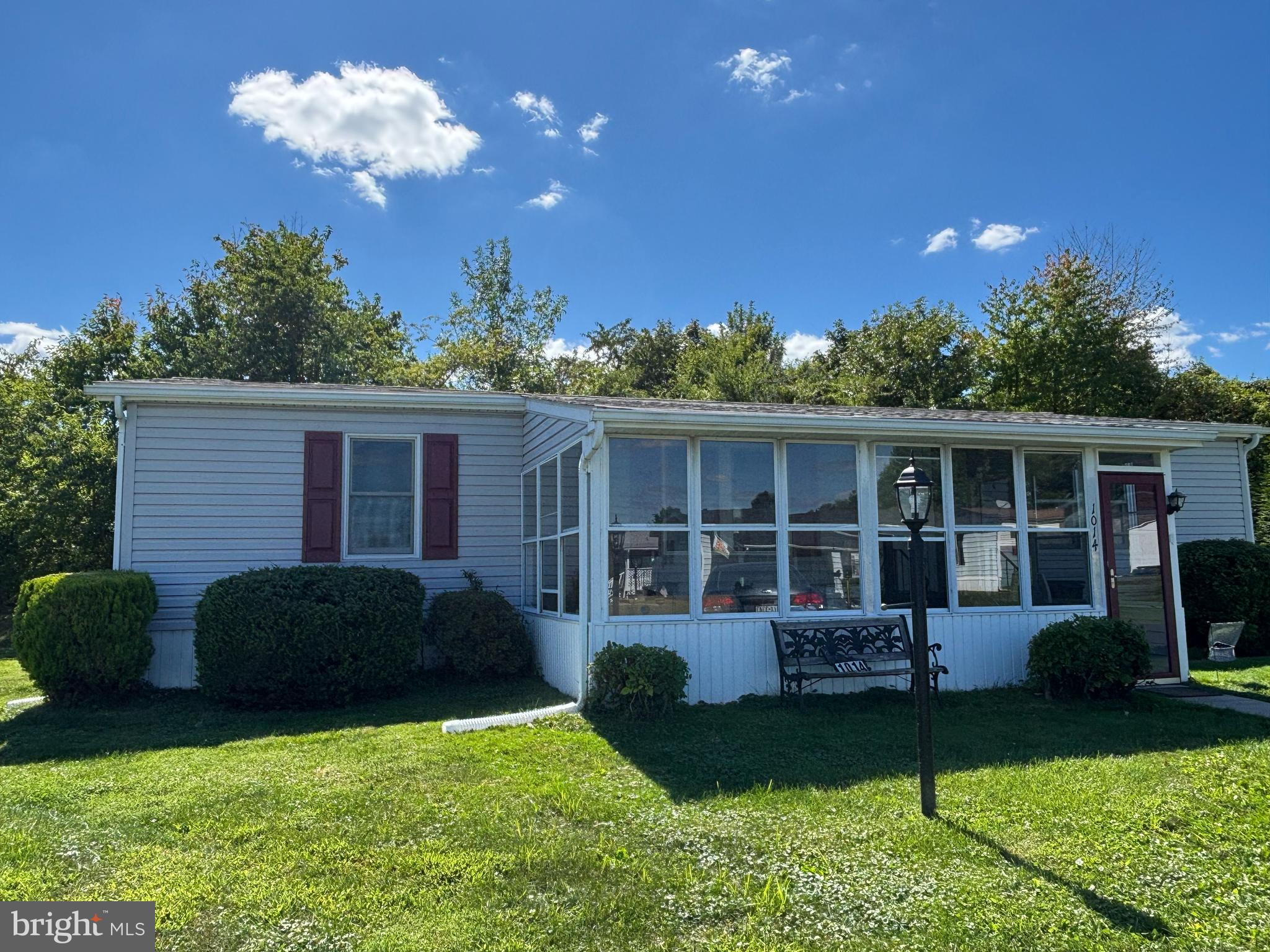 Discover this inviting home with numerous updates, featuring three spacious bedrooms and two bathrooms, now available in the 55+ Village of Neshaminy Falls. You'll appreciate the convenience of two nearby parking spaces and a short pathway leading to a roomy enclosed porch, ideal for enjoying the sights of passing neighbors while listening to the cheerful chirping of birds.
For those who need assistance, a handy stair glide is installed, providing easy access to a generous living room that flows seamlessly into the kitchen and dining area. The dining room, highlighted by an elegant overhead chandelier, connects to an eat-in kitchen complete with a newer refrigerator, dishwasher, and stove/oven.
The laundry room, which includes a closet, comes with a washer and dryer provided in "as is" condition. The large primary bedroom features an ensuite bathroom equipped with tile floors and an updated bathtub surround. On the opposite side of the home, you will find two additional well-sized bedrooms and another updated bathroom with a roll-in shower and vanity also featuring tile floors. This home also includes a newer roof (2020) and extra insulation in the attic, with updated siding, shutters, downspouts, ceiling fans in the kitchen and bedrooms, and newer Anderson windows. Don’t miss the opportunity to make this lovely home your own—schedule your appointment soon!
