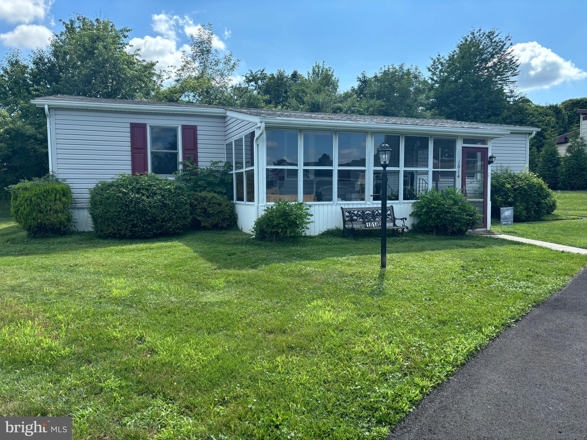 Discover this inviting home with numerous updates, featuring three spacious bedrooms and two bathrooms, now available in the 55+ Village of Neshaminy Falls. You'll appreciate the convenience of two nearby parking spaces and a short pathway leading to a roomy enclosed porch, ideal for enjoying the sights of passing neighbors while listening to the cheerful chirping of birds.
For those who need assistance, a handy stair glide is installed, providing easy access to a generous living room that flows seamlessly into the kitchen and dining area. The dining room, highlighted by an elegant overhead chandelier, connects to an eat-in kitchen complete with a newer refrigerator, dishwasher, and stove/oven.
The laundry room, which includes a closet, comes with a washer and dryer provided in "as is" condition. The large primary bedroom features an ensuite bathroom equipped with tile floors and an updated bathtub surround. On the opposite side of the home, you will find two additional well-sized bedrooms and another updated bathroom with a roll-in shower and vanity also featuring tile floors. This home also includes a newer roof (2020) and extra insulation in the attic, with updated siding, shutters, downspouts, ceiling fans in the kitchen and bedrooms, and newer Anderson windows. Don’t miss the opportunity to make this lovely home your own—schedule your appointment soon!