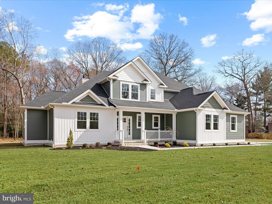 New Construction: Discover this gorgeous 2-story home nestled in the prestigious community of River’s End, offering a private oasis on a serene 1-acre lot framed by a picturesque backdrop of mature trees. Crafted with unparalleled quality and precision by Dabar Home Builders, this home perfectly balances sophisticated design and everyday comfort.  The exterior makes a lasting impression with its sweeping concrete driveway, charming sidewalk leading to a welcoming covered front porch, manicured landscaping, and striking modern Monogram vertical siding. Architectural roof shingles, upgraded 5” K-style gutters, a finished side-entry 2-car garage, a rear paver patio, walkway, and a fully equipped irrigation system enhance the curb appeal of this exceptional residence.  Step inside to experience a grand open floor plan enriched by soaring 2-story ceilings, a luminous foyer, feature lighting, high-end ceiling fans, and expansive windows that bathe the interior in natural light. Luxury vinyl plank flooring flows seamlessly throughout, offering both style and durability.  At the heart of the home lies the gourmet eat-in kitchen, an entertainer’s dream showcasing exquisite quartz countertops, crowned Kraftmaid soft-close cabinetry with pull-out drawers, and a generous island illuminated by pendant lighting with added storage. The impressive walk-in pantry with built-ins provides ample space for culinary essentials. A premium suite of GE stainless steel appliances includes a 5-burner gas cooktop with a range hood and double ovens featuring WiFi connectivity, ensuring every culinary creation is a delight.  The living space extends gracefully to the dining area, perfect for hosting memorable gatherings, and a spacious living room adorned with double-stacked windows, a cozy gas fireplace, and a thoughtful bump-out design that invites relaxation.  Retreat to the luxurious main-level owner’s suite, a true haven highlighted by a tray ceiling, charming bump-outs, and an expansive 11 x 9 custom walk-in closet with expertly designed shelving. The spa-inspired ensuite bath is a masterful blend of elegance and functionality, offering an 87” quartz dual sink vanity, a stunning walk-in shower with subway tile walls, hexagon floor tiles, dual shower systems with a rain showerhead and handheld system, bench seating, and a freestanding soaking tub. A private water closet completes this sophisticated retreat.  Completing the main level is a refined home office with French doors, a functional mudroom enhanced by a custom built-in featuring individual cubbies and hanging hooks, abundant storage closets, and a stylish powder bath.  A beautiful turned balustered staircase gracefully leads to the upper level, where a versatile loft area serves as the central hub for three additional bedrooms. One of the bedrooms boasts a private ensuite, while the others share a well-appointed hallway bath, all featuring elegantly tiled tub surrounds.  Modern amenities provide superior comfort and peace of mind, including a Rinnai tankless water heater, a conditioned and dehumidified crawlspace, and two sump pump systems ensuring worry-free living.  Rivers End is a pristine, tucked-away community nestled along the naturally beautiful Deep Creek, featuring a community pond with a charming picnic area. Enjoy convenient access to Rt. 13, with just a 1 hour and 30-minute drive to the DC area and a mere 45-50 minute drive to the Delaware beaches.  This simply perfect home awaits your arrival—schedule your private tour today!