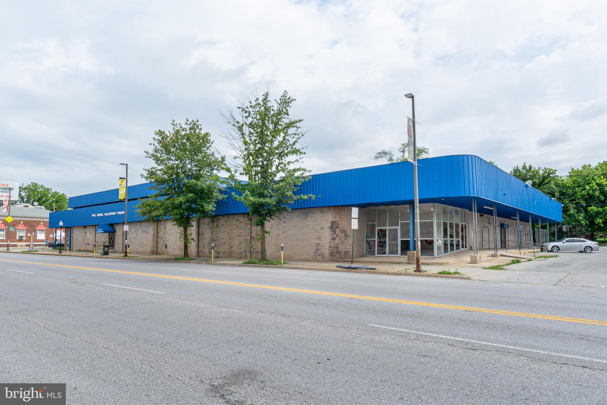 EXPANSIVE COMMERCIAL PROPERTY WITH OVER 22,000 SQ. FT. OF SPACE IN A HIGHLY VISIBLE LOCATION! Property encompasses almost an entire block and is currently used as a church but has endless possibilities. Features include multiple large spaces, 6 half baths, 6 office spaces, roll up drive in door, and a parking lot with ample parking. Sold As-Is