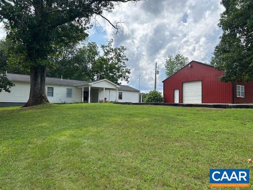 Don't miss this very private 5.282 Acre mostly fenced parcel that is park-like about half open and half wooded. Home has been recently updated. The combined Foyer Living Room has a 50's style Ice Cream Bar, updated Juke Box and two booths with tables and bench seating.  The large eat-in kitchen has a colorful backsplash behind the counters.  The Primary bedroom opens to a large bathroom with Jetted tub and separate shower.  The second bedroom is very roomy.  The office/study has a built in shelf/desk and opens to the rear deck.  The laundry room has a built-in folding table.  Outside are two large covered concrete patio/porches very suitable for relaxing and morning coffee.  Outbuildings include a 30X34 garage/workshop with 12 ceiling and a 10x10 overhead door with opener.  There is room to park three vehicles and 34 foot long workbench waiting for a tinkerer.  There is also a large storage building and an attached lean-to enclosed shed.  Enjoy your new retreat!