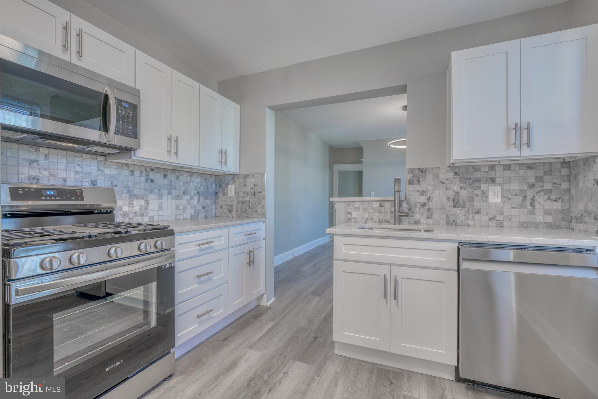 Completely Renovated, so Elegant ! All new Kitchen with Stainless Appliances, Quartz Countertop, Coordinating Mosaic Backsplash, Wood Shaker Cabinets, and Pantry. First floor Powder room. Upstairs Bathroom features Custom Tilework with two-tone Calcatta Tile, Designer Fixtures, and Designer Lighting. Master Bedroom features Cathedral Ceiling and 2 closets. Basement Suite with Bedroom, and Full Bathroom. New Flooring and Carpet, New HVAC System, Front Porch and Covered Deck in rear, Replacement Windows, Cool Lighting. Bonus extra lot for parking in rear. You will Love this Home