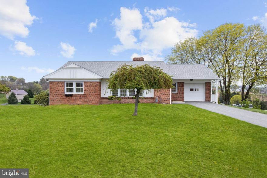 Welcome to this well-maintained solid brick rancher, nestled in a peaceful rural setting with scenic country views in both the front and back. Built and owned by the same family for the past 71 years, this home has been lovingly cared for and is now ready for its next chapter.
Step inside to find beautiful hardwood floors throughout the main level, a cozy living room with a wood-burning fireplace, and a large picture window that fills the space with natural light. The eat-in kitchen and formal dining area offer plenty of room for everyday living and entertaining.

Three spacious bedrooms and a full bath complete the main floor. The walk-out basement provides ample storage space and includes a second full bathroom—great for added flexibility or future finishing potential.

Enjoy your mornings or unwind in the evenings on the covered rear porch, the perfect spot to sip a cup of coffee while overlooking the peaceful fields behind the home.

Additional highlights include an attached garage in the front, a second attached garage in the rear, and generous outdoor space.

With timeless charm, solid construction, and so much potential, this home is a rare find. Schedule your tour today.