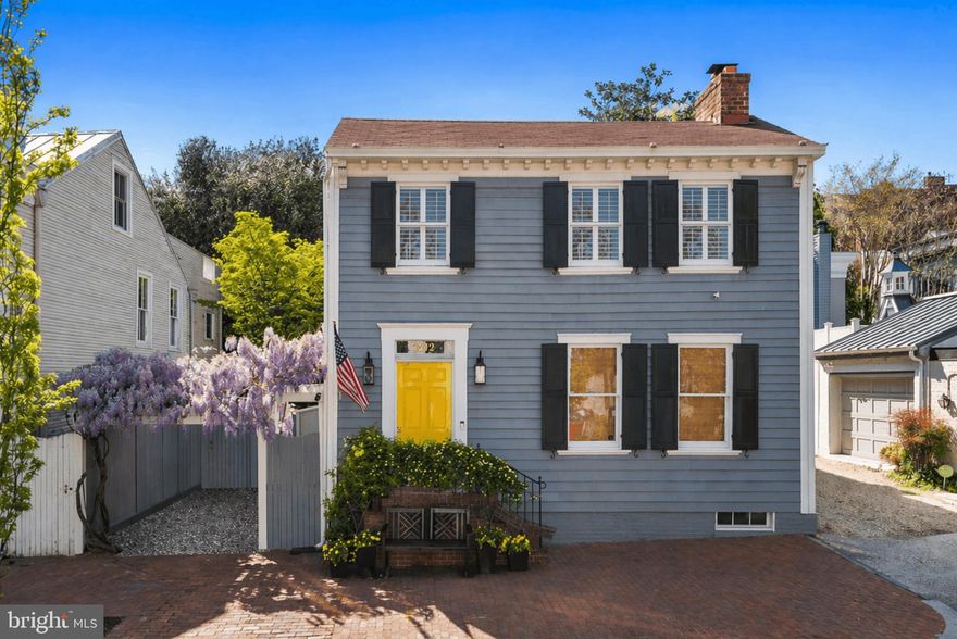 Ideally located in the true heart of Georgetown’s East Village, 1412 28th Street NW redefines curb appeal - Complete with 1-Car Parking. This bespoke residence is a true jewel box, meticulously reimagined by its owner, a local, renowned interior designer, where every finish, fixture, and sightline has been curated with intention. From the moment you enter, the interior is a treat for the eyes. From the inviting living room, beset by glossy walls, custom built-ins, and a fireplace, the home opens dramatically into a sun-drenched great room defined by soaring two-level ceilings and an extraordinary infusion of natural light. A cozy family room with a fireplace graces the level, adjoined by the effortless 12-person dining area. An expanse of windows and French doors effectively opens the main level to the flagstone terrace, allowing for seamless indoor-outdoor living. The kitchen is equally tailored, blending beauty and function with soft-close cabinetry, integrated drawer lighting, and solid brass hardware. High-end appliances, including a Sub-Zero refrigerator and paneled under-counter beverage fridge, are discreetly incorporated, maintaining the clean, tailored aesthetic while offering top-tier performance. The home’s two upper-level suites are serene retreats, including a primary suite featuring a whirlpool soaking tub made all the more luxurious with heated bathroom floors and a heated towel rack, plus an adjoining dressing area with ample closet space. A second suite with a full bath and a separate, generous laundry room completes the level. The lower level offers a comfortable, more casual family/media room anchored by a gas fireplace, creating a cozy secondary living space ideal for relaxing or entertaining. Outdoors, the property transforms into something truly special. The surrounding plantings which are nothing short of enchanting, help deliver exceptional curb appeal—especially in spring, when the flowering landscape is at its peak, featuring peeks of wisteria out front and carefully selected surrounding plantings beyond the front gate. The side and rear exterior feature tiered flagstone terraces which set a romantic and private oasis along the home’s hidden exterior, complete with ambient landscape lighting, water feature, and multiple spaces designed for gathering. It’s an environment that feels worlds away from the city yet mere moments from the best of the neighborhood, just a few blocks between both Rose Park and Wisconsin Ave. Completing the offering is secure one-car parking directly off 28th Street—an invaluable convenience in this coveted location. Don’t miss this Georgetown gem!