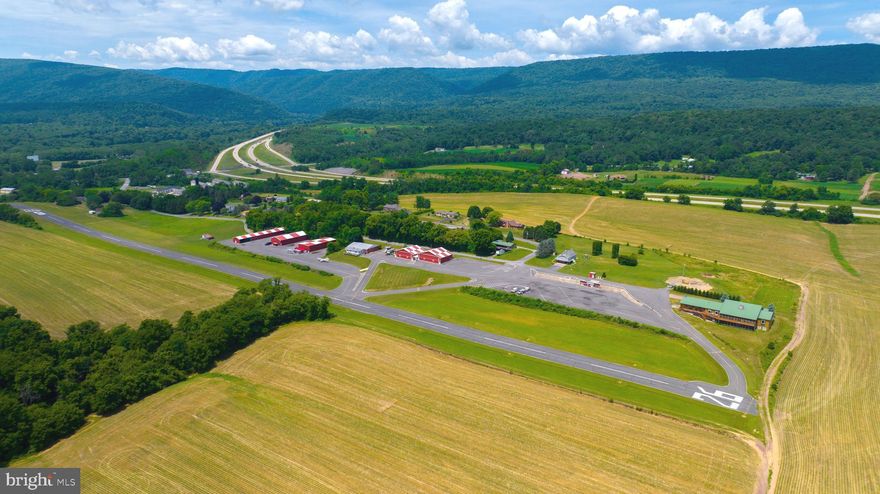 You are cleared for landing! Welcome to Mifflintown Airport, a 24-acre private oasis in Juniata County, surrounded by a peaceful setting of scenic mountains, serene farmland, and the Juniata River is just a couple blocks away. The property is conveniently located between Harrisburg and State College/Penn State University. The property is highlighted by a 2,650-foot paved and lighted runway with a GPS approach, a custom 12,000 plus square foot owner's home that has a brand new enclosed in-ground pool for year-round enjoyment, over 23,000 square feet of hangars, 6,000-gallon fuel storage, two residential rental properties, an apartment, and an additional residential home that can be redeveloped into a hangar home. Mifflintown Airport is unattended and based aircraft owners are extremely helpful in maintaining the facility. The airport can handle most turboprops. The local RC airplane club is also based at the airport. Mifflintown Airport is only 140 air miles west of Teterboro Airport in New Jersey, 145 air miles from Northeast Philadelphia Airport, and a 55-minute drive to Harrisburg International Airport. The airport features 23,000 square feet of hangars in 13 different units. Three of these hangars (9,400 square feet) are heated. The airport has 6,000 gallons of fuel storage set up for two fuels. The property offers 3.5 acres of undeveloped land as well. The owner's home, sitting on 2.2 acres and separately deeded, was completed in 2008 and is 12,000 plus square feet, including 9,800 square feet on two floors, a 1,600 square foot heated garage that can be opened to 37 feet of free span, and a 1,504 square foot screened-in porch. Many windows and glass doors offer unlimited opportunities to enjoy the surrounding views. Hardwood floors can be found throughout. The home is set up with three bedrooms, but more can be added. The owner's suite includes a cedar lined walk-in closet, a whirlpool tub with a bay window, and an oversized walk-in shower. The lower-level bedroom has its own bath with a jacuzzi tub and walk-in shower. The home has an additional full bath too. The modern kitchen boasts oak cabinets and granite countertops. Stainless steel appliances include a large gas cooktop with grill and griddle, and a warming drawer. The main living room boasts a vaulted wood ceiling and a pellet stove in a stone chimney encasement. The full, finished lower level provides a home theater, fireplace, cedar lined closet, and a large area for various recreational activities. The complete U.S. sectional map is epoxied into the floor. A covered front porch surrounds the front of the home while a rear deck encases the back with a covered area next to the kitchen for year-round grilling. Outside, a new vineyard was planted in 2019. The owner's home comes with an alarm system, a video system, a separate RO water system, a telephone system and high-speed internet great for a remote office. The residence has two air conditioning systems and is completely heated with automatic wood pellet fired boilers. There is potential to build a hangar and a housekeeper apartment on the owner’s lot as well. Don't wait to schedule your visit and see this amazing property with your own eyes today!