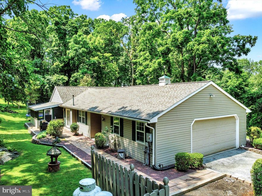 Prime location in walking distance to Pinchot Park and just an 8 minute drive to Ski Roundtop! This Wellsville Ranch Style home offers a tranquil setting and sits on 1.5 acres! This is a 3 bedroom, 2 full bath home with newer LVP flooring, fresh paint,  a large eat - in style kitchen which features solid wood cabinets, island storage and large eat in area. The family room is quite large and has ample natural lighting along with a pellet stove.  There is a screened in porch to enjoy the sunrise or sunsets. The convenience of 1st floor living with main floor laundry and storage space in the oversized 2 car garage. All 3 bedrooms are great in size. The owner's bedroom has a private full bath and there is a 2nd guest bath in the hall. Outside you'll LOVE the landscaping work put in and the well maintained yard front to back! The oversized 2 car garage is great but there is also plenty of storage room in the large shed and massive carport. This home has a newer roof and newer central air! Call to schedule a tour or to learn more!