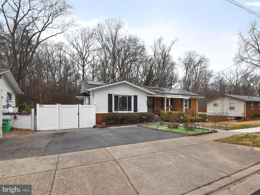 This home has the flexibility for multi-generational living, featuring beautiful hardwood floors throughout, a primary suite, two additional bedrooms, and two full baths on the main level. The expansive living room is filled with natural light and connects to an enclosed deck with views of the woods. The roomy eat-in kitchen includes a bounty of windows for more sunlight, granite countertops, and white cabinets. The lower level boasts a spacious multi-purpose den with a bar, an additional primary bedroom, a full bathroom, and a very generous walk-in closet. Outside, there's a covered patio with a 6-person hot tub, a shed, and a spacious, private, fenced backyard with plenty of green space for outdoor gatherings. Additionally, there is a washer and dryer on each level, a 2-car driveway in the front, and a leased solar system. The location provides easy access to I-495, BW Parkway, Route 50, the University of Maryland, College Park Metro, New Carrollton Metro/MARC Train, and various restaurants and shops.