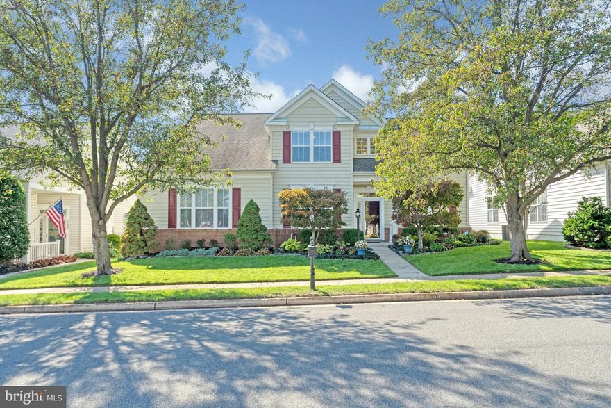 The pride of ownership shows in this 4BR, 3BA single family home located in a 55+ community that offers not just a place to live, but a lifestyle to embrace.  Step inside to the grand two-story foyer that leads to sophisticated living areas. An abundance of natural light pours throughout to illuminate the rich hardwood floors, which adds to the overall charm. The stunning character of this home will embrace you with crown molding, chair rail, shadow boxes, and 9ft ceilings. The formal living room is set apart for formal entertaining. The elegant dining room will host intimate meals for family and friends. The spacious family room is designed for informal gatherings and has a high sloped ceiling, and gas fireplace. The modern kitchen offers everything a cook could want - complete with GE appliances, granite counters, ceramic tile backsplash, double wall oven, electric cooktop, under cabinet lighting, a pantry, and recessed lighting. The breakfast nook opens onto a stone patio to expand leisure activities to the outdoors. The mud room with front loading washer and dryer provides offers lots of convenience. The main level primary bedroom suite, where comfort meets style, offers a sitting area, large double walk-in closets, ceiling fan, and private bath. The primary bath features double vanities, vanity desk, soaking tub, and a glass enclosed shower with bench. The secondary bedroom provides plenty of space for sleep, storage or play. Upstairs, features a spacious multi-purpose den overlooking the family room. The two additional bedrooms are equally inviting, providing a cozy haven for guests. Outside, the stone patio provides a private oasis for relaxation, or entertaining family, and friends. The attached two car garage offers built-in cabinets to help keep things handy but out of sight. Enjoy all the luxuries the Dunbarton community clubhouse has to offer. Conveniently located to major commuter routes, shops, and restaurants. Don't miss the opportunity to call this wonderful home yours!