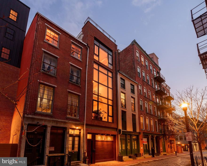 OPEN HOUSE THIS SATURDAY FROM 12:00 NOON TO 2:00 ! 

Architecturally unique Minimalist townhouse built 2005. Designed by Janice Woodcock & Associates of Old City, Philadelphia.

This Glass Curtain Wall Facade, 4 story home, is located on the cobblestone alley behind historic Christ Church and the Arden Theater, both are pillars of the Old City community.

1st Floor:

Mixed use space. Entrance to house and 2 car temperature controlled tandem garage. Mirrored Gym/Yoga studio. Big Ass Haiku Fan. Full Bath. Lots of storage space, generous (1,000+ bottles) Wine Cellar with N’finity SC3000 Whisperkool climate control system. Murphy bed for overnight guests.

2nd Floor:

Main living space consists of central atrium soaring 40’ to top of 12’ skylight. The translucent stairs wrapping around this space lead all the way to the 3rd Floor. Living room on this floor has 22’ H window facing the street below. The floors are 3/4" solid wood “Character Hickory”. Kitchen/Dining areas are on alternate side of central atrium. Lacquered Cherry cabinetry and Viking appliances throughout. Counter tops and Island are black granite. There is a powder room off of the atrium, and sliding glass doors lead to a small deck off of the dining area where you can grow herbs, cook your dinner on a real charcoal grill, or simply enjoy a glass of wine.

3rd Floor:

Cosy loft seating area with gas fireplace looks down into the 2nd floor living room, and directly out to the same 22’ glass curtain wall. On the alternate side of the open central atrium are two bedrooms and a full bath in between. These rooms could also be used as offices, or dens.

4th Floor:

Primary Bedroom Suite constitutes the entire 4th floor. The bed chamber has a floor to ceiling window (which completes the “curtain wall effect from the exterior) with a vivid view of the Christ Church steeple. The hallway leading to the walk in closets, laundry room and full bath with oversized shower, passes along the open central atrium just beneath the large skylight. The natural light in this space is wonderful. The bath chamber also boasts a free standing soaking bathtub and acres of Calacata Borghini Carrara marble tile.

Rooftop Deck:
Reached by hardwood stairs from 4th floor. Great views of the Christ Church Steeple, Ben Franklin Bridge, and the U.S. Customs House

*Some photos are virtually staged
