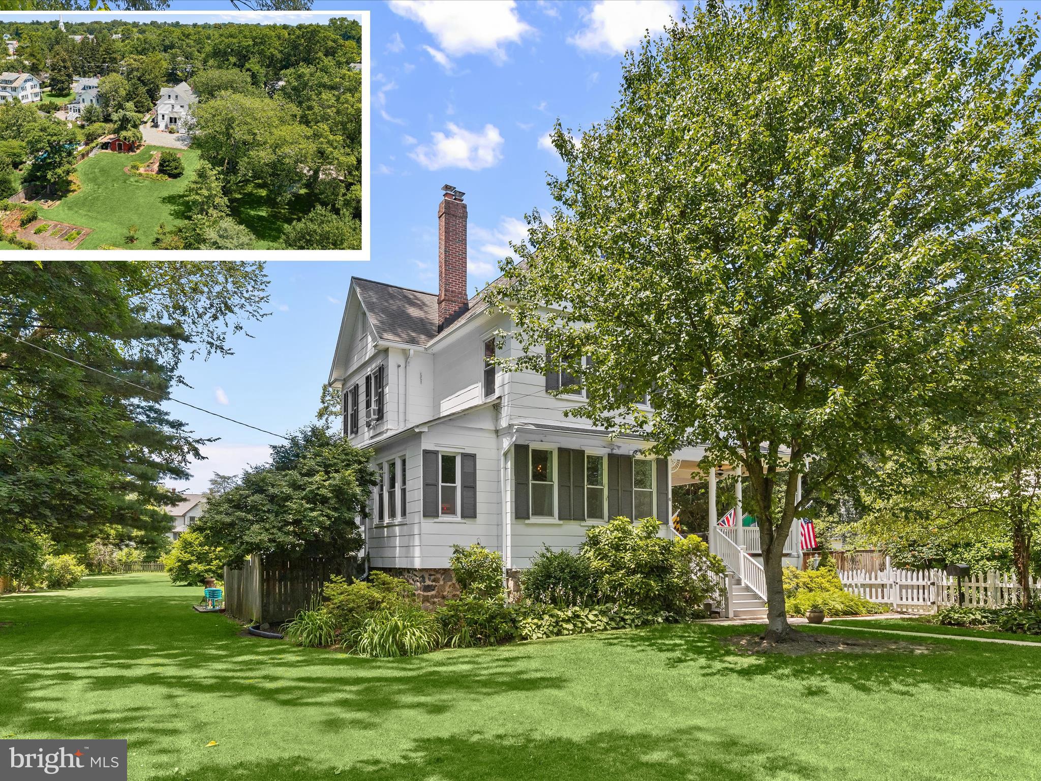 Step into a perfect blend of history and modern comfort with this stunning 1915 Victorian, nestled on nearly an acre in the heart of beloved Catonsville. Brimming with character and updated for today’s lifestyle, this 5-bedroom, 2.5-bath home offers generous space, timeless design, and an unbeatable location. A classic white picket fence and wraparound front porch welcome you into a grand foyer adorned with soaring ceilings, intricate moldings, and original inlaid hardwood floors. Throughout the home, rich architectural details like original doorknobs and hardware, crown molding, and intricately carved newel posts blend effortlessly with thoughtful updates such as modern light fixtures and stylish finishes. The formal living room exudes warmth and charm with a wood-burning fireplace and an adjoining sitting room, perfect as a home office or reading nook. French doors open to a gracious dining room framed by bump-out windows, creating an elegant setting for everyday meals or special gatherings. The renovated kitchen balances function and style with white cabinetry, granite countertops, timeless subway tile backsplash, and stainless steel appliances. Upstairs, the primary suite offers a peaceful retreat with a beautifully updated en-suite bath featuring a floor-to-ceiling tiled shower, frameless glass door, and rainfall showerhead. A connected room to the primary bath provides flexible space for a walk-in closet, nursery, or optional bedroom. A second spacious bedroom with its own sitting room and a full hall bath with a classic clawfoot tub round out this level. The top floor offers three more bedrooms and a closet space that could be converted into an additional bath. The lower level, recently waterproofed, includes laundry facilities and walkout access to the backyard. Step outside and enjoy a setting reminiscent of an English garden, complete with brick paths, raised vegetable beds, a fire pit area, and a greenhouse tucked along the side of the home. The spacious, fully fenced yard offers plenty of room to gather, relax, or grow. A covered portion of the rear deck overlooks the peaceful landscape, while the detached garage featuring shake siding, electric, and a lean-to for extra storage adds both function and charm to the extended parking area. All of this sits just moments from the best of Catonsville. Steps to schools, restaurants, shops, local farmers market, and summer music events. A rare opportunity to own a true piece of history in a vibrant, close-knit community. This one is not to be missed.