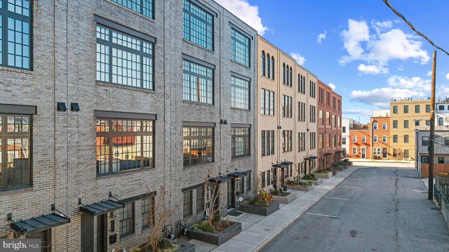 A rare offering in coveted Brewer’s Green, this expansive townhome delivers refined city living with scale, light, and luxury, beautifully balanced on a quiet residential street.
Built in 2018 and spanning over 2,600 square feet, the home’s generous 17-foot width creates a sense of openness rarely found in Baltimore townhomes. Ten-foot ceilings, oversized front and rear windows, and rich hardwood floors throughout set an elevated tone from the moment you enter, filling each level with natural light.
The main living level is designed for both everyday ease and effortless entertaining, featuring a spacious living and dining area anchored by a stunning, high-end kitchen. Here, premium GE Monogram line appliances, a large center island with seating, and thoughtfully selected finishes come together with both style and function in mind.
With four bedrooms, each offering its own ensuite bath, the layout provides exceptional privacy and flexibility for family, guests, or work-from-home living. Electronic shades, refined details, and impeccable finishes reflect a commitment to quality at every turn.
Crowning the home is an exceptional rooftop terrace providing an ideal retreat for morning coffee, evening gatherings, or simply enjoying the city skyline and waterfront views. A one-car garage adds everyday convenience without compromise.
Perfectly positioned near neighborhood shops, dining, fitness studios, and the scenic paths of Canton Waterfront Park, with quick access to I-95 and I-895, this home offers a lifestyle that feels both connected and quietly luxurious.
This is Brewer’s Green living at its finest; rarely available, beautifully executed, and ready to be enjoyed.