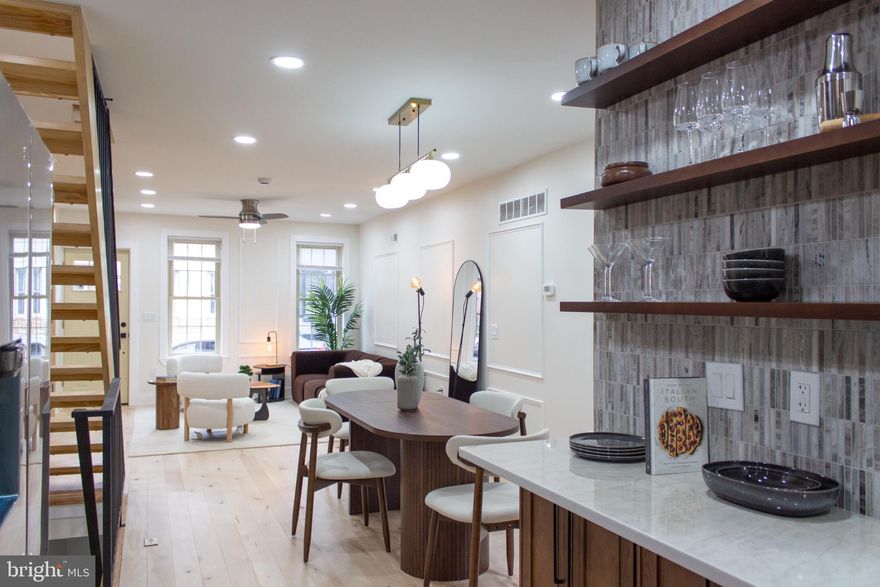 Welcome to 2443 Memphis Street, a thoughtfully renovated 2-bedroom, 2-bathroom home in the heart of Fishtown.

Behind the classic brick façade, the interior blends clean, modern finishes with strong architectural character. Exposed brick, custom slatted wood detailing, and wall moldings add texture and dimension throughout, giving the home a distinct, design-forward feel without losing its original charm.

The main level offers an open living and dining area finished with light hardwood floors that keep the space bright and airy. A framed brick feature wall and vertical slat accents create a natural focal point in the living room. The kitchen pairs natural wood cabinetry with quartz countertops, stainless steel appliances, and a contemporary tile backsplash—both functional and visually polished. A full bathroom on this level adds flexibility for guests or everyday convenience.

Upstairs, you’ll find two bedrooms and a second full bathroom. The upper-level bath is designed with a glass-enclosed shower, a freestanding soaking tub, and the added convenience of second-floor laundry.

With layered architectural details, balanced finishes, and a smart layout, 2443 Memphis Street delivers modern living in one of Fishtown’s most vibrant neighborhoods, just steps from local dining, shopping, and everyday essentials.