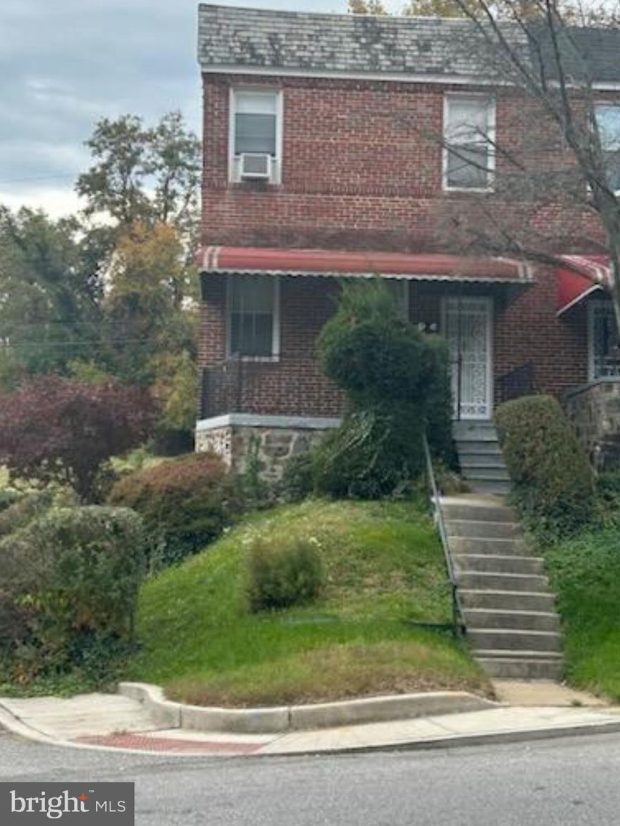 Gem in Greenspring! Charming end-unit row home, perched perfectly upon a hill overlooking the Greenspring neighborhood of Baltimore, MD. Being sold As-Is.  This home offers 3 generous-sized bedrooms and 1 full bathroom.  There is a cedar closet in the Primary Bedroom, possibly hardwood floors (currently covered by carpeting) on the upper level, Formal dining room, Livingroom with a Fireplace and a partially finished basement. Window A/C units in all bedrooms, living room and dining room to keep you cool in the Summer. Oil heat to keep you warm in the Winter. Home comes already equipped with an alarm system. There is convenient parking at the rear and to the side of the home.  The rear entrance leads you right into the kitchen. A spacious covered front porch is the perfect space to relax and unwind at the end of your day. The finished area of the basement could be a great space for an in-home movie theater. The unfinished area of the basement is a useful area as well…picture a workshop, crafting area or just a great space for organized storage. The possibilities for your creative touch are endless! Come make this your dream home!