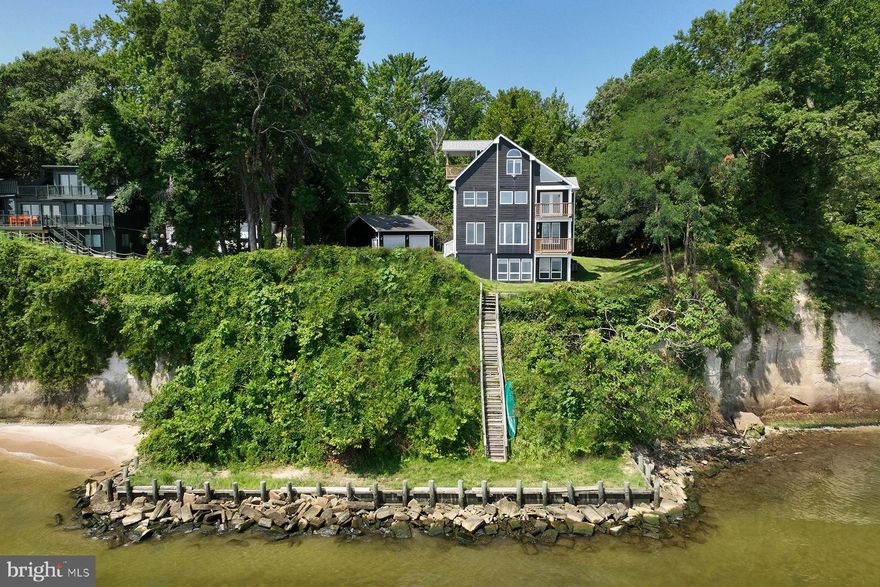 6447 Randle Avenue in Chesapeake Beach offers endless Chesapeake Bay views: here you will find “The Bay Home” you’ve always wanted! The covered front porch welcomes you into the main level with walls of glass that highlight the amazing Bay views. Whether you choose to sit on the waterside balcony to hear the waves lap upon the shore or to admire the view from indoors during colder months, you will enjoy the open concept main level. It has plenty of room for entertaining and everyday living, including a home office alcove and separate dining area. There are hardwood floors and an updated kitchen with new granite counters and stainless steel appliances. 

The 2nd level offers a spacious primary suite with BIG VIEWS of the bay, and there’s enough room for a sitting area facing the water. Or, step out on the balcony to welcome the sunrise. The updated ensuite bath has separate vanities, a waterside soaking tub, and separate shower. The vaulted ceiling adds to the brightness of the space and don’t forget the ample walk-in closet. A second bedroom, with water views, is around the corner and there is a full bathroom on this level. The washer & dryer are conveniently located off the hall.

The 3rd level features a water view bedroom with palladian window and private porch. Here’s the go-to spot to read a book and relax in the shade while enjoying the bay breeze and views. There is a fourth bedroom on this top level as well as a half bathroom. The walk-out, lower level is a pleasant surprise as it too has big views and loads of natural light. This large space provides flexibility that's perfect for a family or game room, home gym and/or a home office. With these views, this will be another gathering spot. There is also loads of storage on this level and a set of French doors that open to the side yard. 

A detached 2-car garage will win the hearts of the car enthusiast, while providing loads of storage. Lastly, the shoreline of this property has a bulkhead with rip rap installed. Take advantage of the private, level yard along the shoreline by bringing a picnic down or a fishing pole. Nearby Chesapeake Beach is a quaint destination, with several restaurants, fishing charter boats, and a 2-mile railway trail.
