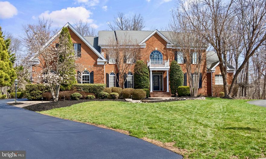 VA Assumable 2.25% for non-Veterans as well on $830,000.
Paradise awaits on a private, tree-lined 1.23-acre cul-de-sac lot in the prestigious Dominion Valley Country Club community.  This exceptional home, the sought-after Estate series, Hampton model, is one of the largest models that Toll Brothers built in the neighborhood.  It offers a rare combination of elegance, space, and thoughtful design that will satisfy even the most discerning buyer.
From the moment you enter the home, you are welcomed by a magnificent marble foyer featuring twin circular staircases leading to the upper level, creating an unforgettable first impression.  Throughout the home, rich Brazilian Cherry hardwood flooring adds warmth and sophistication to the luxurious custom floor plan.
The gourmet kitchen is truly a chef’s dream, featuring upgraded stainless-steel appliances, a wall-mounted GE Monogram refrigerator, double wall ovens, a massive island with a built-in sink, and a wine fridge.  Additionally, there are two dishwashers, a 6-burner gas range with decorative hood, Yorktowne top of the line custom cabinetry, and a spacious custom-built walk-in pantry.  
A stunning wall of custom glass doors creates a breathtaking connection between the kitchen and outdoor deck patio.  These expansive floor-to-ceiling panels flood the home with natural light while framing serene views of the private deck and wooded backdrop beyond.  Designed to blur the line between living space and nature, the doors open effortlessly to create a seamless indoor-outdoor entertaining experience.
Perfect for both everyday living and entertaining, the kitchen flows effortlessly into the welcoming family room with cherry wood coffered ceilings, a beautiful fireplace with a stone hearth, and a dramatic mantle.
The main level also features an elegant formal dining room, a charming sitting and music room, a private office, two conveniently located half bathrooms, and a luxurious main-level primary suite with a spa-inspired bathroom, Jacuzzi tub, separate shower, and double vanity.
Upstairs, the home continues to impress with a second expansive primary suite featuring an enormous en-suite bathroom complete with double toilets, double-head showers, a large Jacuzzi tub, built-in closets, and private his and her dressing rooms.  Three additional bedrooms each offer their own private en-suite bathrooms, providing comfort and privacy for family and guests.  An oversized bonus room, perfect as a playroom, game room, study area, or creative space, adds even more flexibility.  One of the home’s three laundry areas is also conveniently located on this level.
The fully finished lower level was designed with entertaining in mind.  Whether hosting family celebrations, birthdays, graduations, or neighborhood gatherings, this space offers incredible versatility with a multi-media room, game areas, one full and one ½ bathrooms, and a fully equipped wet bar, including a freezer large enough to store multiple ice cream bins for unforgettable dessert moments.
Step outside to your own private resort-style retreat.  The covered patio opens to an expansive pool deck, a six-person hot tub, and a custom-designed swimming pool with a diving board.  Beyond the fenced pool area, the remaining grounds offer space to explore and enjoy nature, including walking and recreation areas, a charming playhouse, and a custom-built fire pit, perfect for evenings under the stars.
Additional conveniences include three separate laundry areas, one on each level, and a spacious three-car garage equipped with an electric vehicle charging port, providing modern convenience and future-ready living.
This extraordinary home offers the perfect balance of luxury, comfort, and entertainment.  Whether enjoying peaceful everyday living surrounded by nature or hosting unforgettable gatherings with family and friends, this property delivers a lifestyle that is truly exceptional.