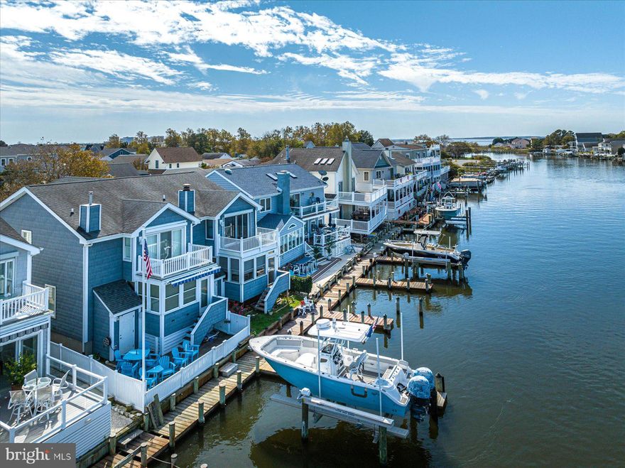 Coastal living at its best! Beautiful waterfront property with a prime location on “The Ditch” on the inner coastal waterway which opens up into the bay. Located in the sought-after community of Caine Woods. This renovated 3 bedroom/2.5 bath coastal home offers a spacious open floor plan. Renovations include all-new flooring, shiplap, beaded board ceilings, a gourmet kitchen with stainless steel appliances, a large pantry, and top-level cabinetry and granite countertops. Wet bar/stop & drop. Upgraded custom bathrooms. Custom painting throughout. All new light fixtures. Custom window treatments with remotes. Brand new Harman pellet stove surrounded by stone Hearth with a handsome mantel from a barn in the 1800's. Additional indoor living space includes a screen porch that was converted to a fully conditioned all-season room. The square footage does not include the conversion of the screened porch to the conditioned living space.  All new windows, and siding. Outdoor living space includes a front porch, a waterfront balcony off of the primary bedroom, waterfront paver patio with a retractable awning overlooking the waterway with stunning views and gorgeous sunsets.  Loaded with custom high end upgrades. Ample storage space.Private boat dock and 2 deep water boat slips, 1 with a lift, with an extended pier on a deep waterway, right outside your back door. Outside storage shed and fenced-in backyard. Paver sidewalk on the side yard. Beautifully landscaped. New HVAC and tankless water heater. All new insulation. Conditioned crawl space. Large garage with heating/air, Corian countertop prep area with high-end cabinetry, and additional storage space. Plenty of off-street parking for guests to visit. No condo fees. Extremely well maintained and cared for. Enjoy this prime location with short walking distance to the sand and surf with many nearby local restaurants, shopping, and bus stations.  Close to award-winning golf links and some of the finest fishing on the East Coast.