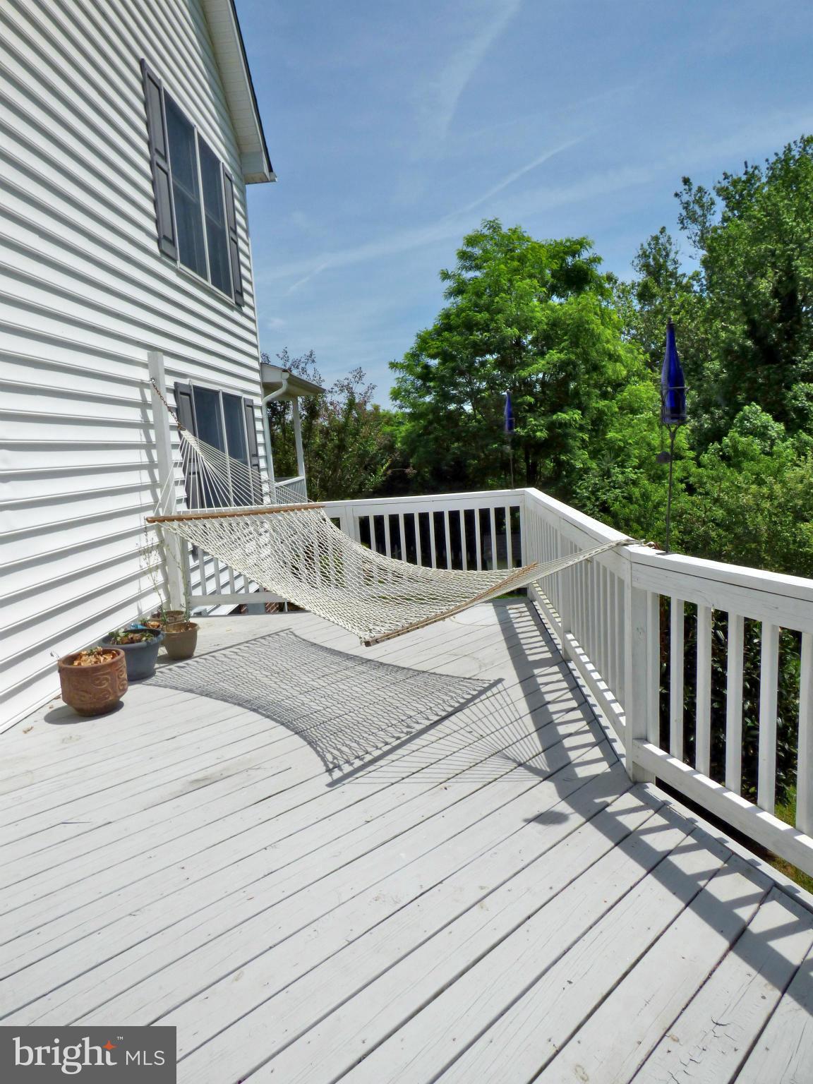 Beauty and tranquility await.. Welcome to your own secret garden. A list of flowers, herbs and plantings available! Covered front porch, large back deck, hot tub can stay! Gourmet kitchen w/ granite counters. Hardwood flooring on all of first floor, each bedroom w/ it's own private bath, green house, shed, detached garage with 20X22 finished rec-room above. Truly a home you will not want to miss!