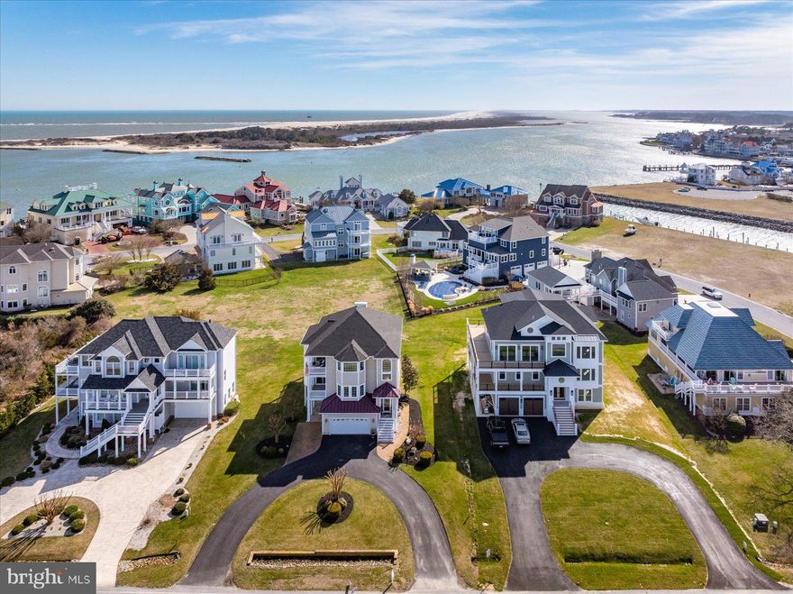 Experience coastal luxury in this stunning home located in the prestigious Martha’s Landing community! Thoughtfully maintained and designed for refined living, this home is ready to impress from the moment you arrive—featuring water views from nearly every room.

The ground level provides incredible flexibility, featuring a private bedroom, living area, full bath, kitchenette (with room to expand into a full kitchen), and washer/dryer hookup—perfect for guests or a separate living space.

Take the elevator to the main level, where you’ll find a welcoming foyer, two spacious guest bedrooms, a full bath, and a versatile office or craft room that could easily serve as a fifth bedroom. The oversized primary suite is a true retreat, complete with a walk-in closet, luxurious en-suite bath, and a convenient wet bar—ideal for enjoying your morning coffee before stepping out onto your private balcony, all while taking in serene water views.

The top floor is designed for unforgettable entertaining, showcasing an open-concept layout with a gorgeous kitchen, breakfast nook, dining area, sitting room, living room, and bar—all enhanced by sweeping water views. Step outside to your balcony and enjoy breathtaking sunsets, watch the OC Air Show, fireworks, and take in the beauty of the surrounding water.

This exceptional home perfectly blends elegance, comfort, and coastal charm—luxury living at its finest.