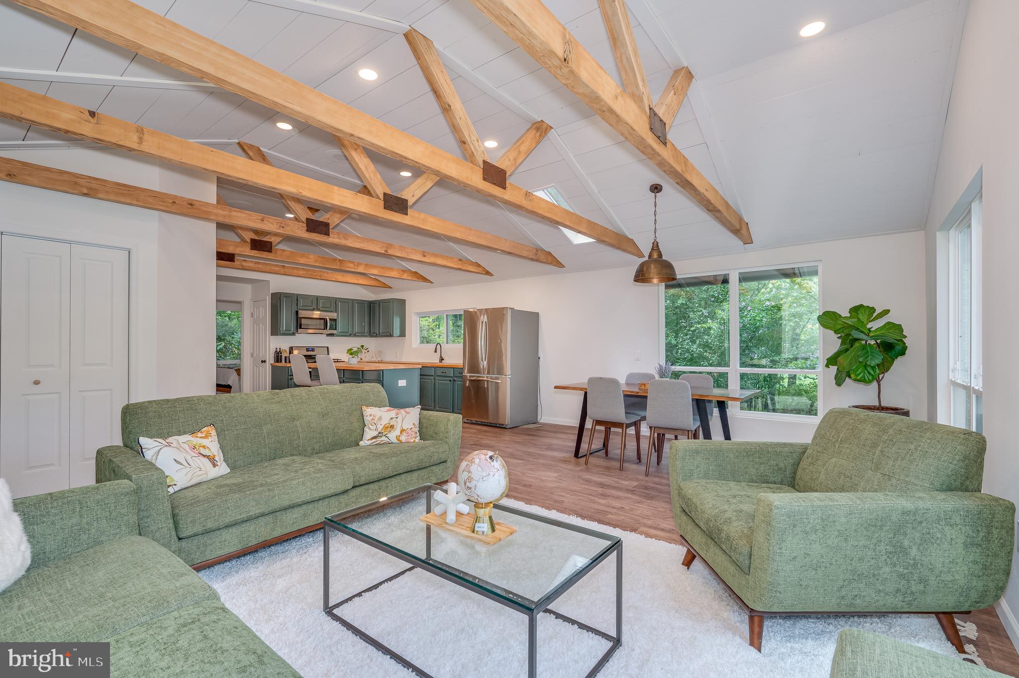 HIGHEST AND BEST OFFERS DUE SATURDAY 7/22/23 BY 6:00PM.
This charming and recently renovated two-bedroom, one-bath cabin is nestled in the mountains of Shannondale. This home is situated on approximately 1.2-acre wooded corner lot. Enjoy the spacious open floor concept with large windows allowing lots of natural light to fill the entire home including the eat-in kitchen, dining area, and living room. These large windows allowing you to fully enjoy the flowing stream in the back yard. Upgraded LVP flooring and exposed wooden ceiling beams throughout. The gourmet kitchen is great for entertaining friends and family. The kitchen presents with stainless steel appliances, butcher block counters tops, oversized island, stainless steel farmhouse sink, and gas cooking stove. Fully renovated full bath, with brand new tub shower, vanity, washer and dryer. Lovely outdoor patio for more entertainment with friends and family. Home is approximately 1030 SQFT now that renovations had been made. There's so much character and love put into this home. Schedule your showing today to see for yourself!
