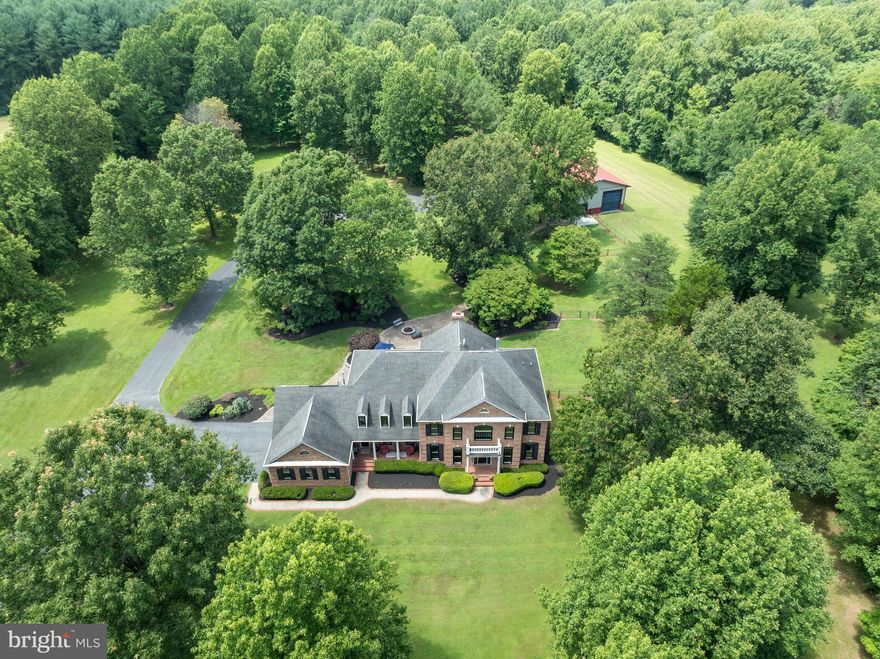 Serenity Awaits, secluded 12.22-acre retreat with Sugarloaf mountain panoramic views only 1-1/2 miles from Route 270/Urbana, and amenities that Urbana offers, Urbana Schools, shopping, and dining.   Welcome to 8418 Peters Road (Southern State of Mind), an exceptional opportunity to own one of Frederick County's premier luxury estates. This distinguished property offers over 7,400 square feet of meticulously finished living space. The estate includes a 40 x 80 shop (an additional 3,200 square feet) equipped with a car lift, electric, heating, and water, ideal for a trades man seeking to conveniently work from home, car enthusiasts, or RV owners. The commercial-grade asphalt provides ample maneuvering space for large vehicles and additional parking for your business operation.

Upon entry, soaring ceilings and abundant natural light highlight elegant flooring and high-end finishes throughout the thoughtfully designed interiors. The stately colonial introduces luxurious living spaces, including a kitchen tailored for culinary excellence. Featuring custom cabinetry, granite countertops, a grand island, premium appliances, custom range hood, separate ice maker stationed in 1 of the 2 prep islands, the kitchen is both functional and stylish. Adjacent areas provide space for dining, a sitting area with a gas fireplace, television, and access to an extensive hardscape patio.

The main level includes a two-story foyer, formal dining room, office, great room, first-floor in-law suite with private bath, mudroom with powder room, full-size laundry room with ample storage, and access to a three-car attached garage. Upstairs, generously sized bedrooms offer comfort and privacy, including a spacious primary suite featuring a large bedroom, sitting area with sink, updated luxury bath with walk-in shower, soaking tub, dual vanity, makeup area, his-and-her walk-in closets, and a laundry chute. Three additional bedrooms each have private baths and walk-in closets.

The lower level features a hobby/theater room with theater wiring, a game room with custom tables and pool table, a wet bar with fridge and dishwasher, a family room with stone fireplace and patio access, a sixth bedroom, full bath, and a storage room with shelving.

Take a deep breath and relax in the back yard and enjoy the outdoors with an expansive brick patio with brick wall overlooking a lush green rear yard with picturesque landscaping, manicured lawn, mature trees, vibrant flower beds, fire pit, winding brick walkway from the house to the shop/garage.  Don’t miss this extraordinary opportunity!