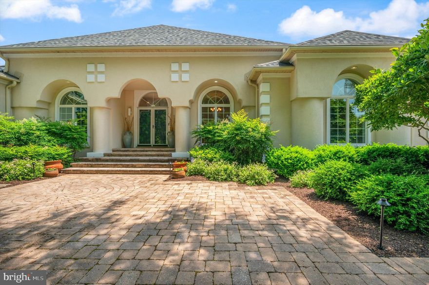 This luxurious 6-bedroom, 4.5-bathroom waterfront estate offers nearly 6000 square feet of elegant living space, perfectly capturing the essence of a sophisticated waterfront lifestyle with its custom-built Mediterranean design. Nestled on almost 2 acres with 416 feet of pristine waterfrontage, this property is truly exceptional—a private sanctuary by the bay. Crafted with unparalleled quality, the home features over 5800 square feet of thoughtfully designed space, including two sumptuous primary suites , along with two guest rooms on the lower level.
Fantastic gourmet kitchen opens to family room with fireplace overlooking unobstructed views of Shipping Creek.
As you enter, you’ll be immediately captivated by the breathtaking views of Eastern Bay that grace the living and dining rooms. The open-concept floor plan seamlessly flows into the fully upgraded kitchen, breakfast area, and family room, where sweeping panoramic views continue to dazzle. Indulge in a cocktail on the expansive screened-in porch while savoring a crab feast, with crabs freshly caught off your private pier. The first-floor primary suite is a tranquil haven, offering unobstructed bay views, a grand walk-in closet, and a lavish en-suite bath with a separate shower, soaking tub, and double vanities. Whether you choose to cozy up by the fireplace or step out through the French doors onto the deck, this space invites relaxation. The main level also features a spacious laundry room and a stylish home office, complete with a pass-through window to the porch, perfectly balancing work and leisure.

Upstairs, the second primary suite is a retreat of its own, with breathtaking water views that invite you to linger in bed. The en-suite bath is a masterpiece, featuring double vanities, marble countertops, a luxurious 5'x8' walk-in shower with an oversized rain shower head, and an expansive skylight that bathes the room in natural light. The lower level is equally impressive, offering two generous guest rooms, a full bath, and an expansive entertainment area with a gas fireplace and wet bar, seamlessly connecting to the outdoor oasis. Step outside to your grand swimming pool, sun-drenched patio, and an expansive deck that spans the length of the home, providing the perfect setting for alfresco living.

The meticulously landscaped lot includes an irrigation system, a powerful 25kW whole-house generator, a private 300-foot pier with a boat lift, and a 2-jet ski lift, making this estate ideal for both family living and resort-style entertaining with a chic, Floridian flair. New roof in 2022! Located just minutes from exclusive amenities including fine dining, boutique shopping, and recreational activities, this exquisite home is the epitome of luxury living. Call today for a private showing.