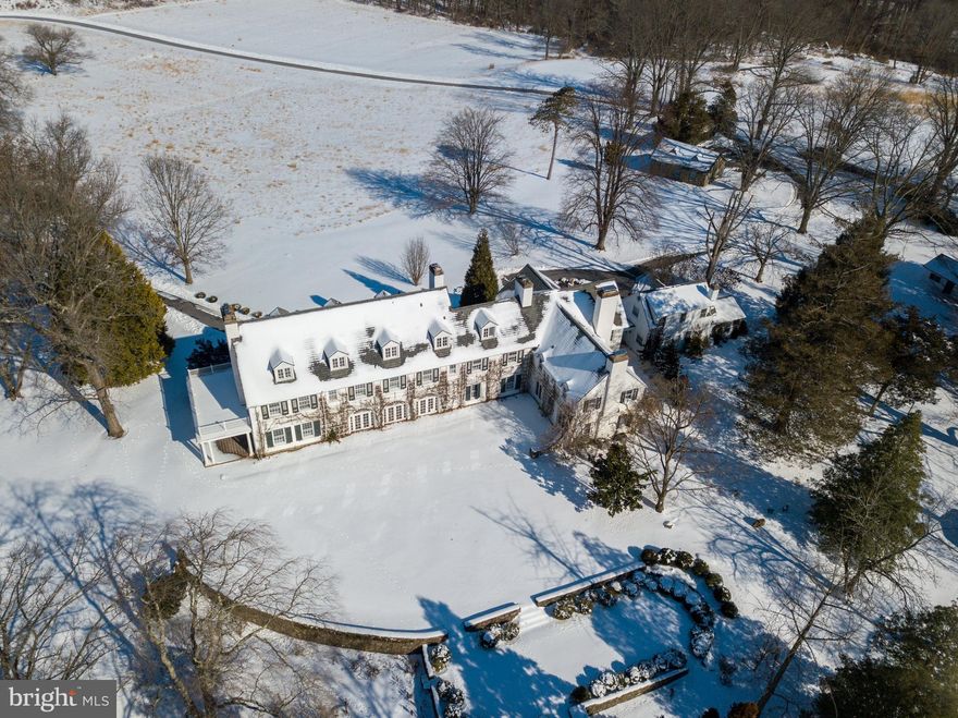 Summerhill is a splendid country estate situated on 17.6 stunning acres in the coveted Radnor Hunt. The home is carefully situated at the end of a long meandering driveway and the approach to this country manor home is memorable leaving a lasting impression on homeowners and guests alike.  This elegant and well-built 1910 solid masonry home is perfectly perched atop rolling hills and offers enduring architectural styling and distant scenic views. It is believed to have been originally designed by the venerable Frank Furness around the turn of the century as a summer retreat for prominent Philadelphians. Gracious living and entertaining is afforded by a remarkable bucolic setting atop rolling hills that define Willistown Township, Chester County. The home offers three floors of flexible living spaces, accented by many fireplaces, large windows, distinctive woodwork and measures nearly 10,000 square feet of comfortable living space. The-two story front entry hall with elevator opens into the sunroom which runs the length of the home with southern exposure, allowing tremendous natural light to this classic beauty. Each room within the home looks out onto both secluded lawns, fabulous stone-walled, terraced gardens and panoramic views. Covered West porch creates a perfect spot to enjoy stunning sunsets. Also attached is a separate one-bedroom guest cottage (circa 1926). Outbuildings include a small cottage/doll's house with enchanting fieldstone working fireplace, a stone hexagonal potting shed/root cellar, and two sets of garages with space for six cars. Plus in-ground pool. Earlier homeowners have donated much of the original property to Natural Lands Trust, now known as Summerhill Preserve, which provdes Summerhill with a sense of unmatched tranquility, privacy and an opportunity to commune with its natural surroundings. Within 45 minutes of Philadelphia, 25 minutes to the PHL Airport, close proximity to the R5 commuter and Amtrak, the Great Valley School District, and a host of private schools,  Main Line shopping and dining destinations. Town & Country living at its finest awaits the next lucky homeowner of  this one-of-a-kind sanctuary.