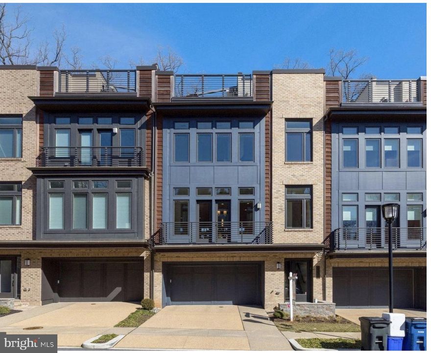 Contemporary EYA-built elevator townhome located in Bethesda's upscale Grosvenor Heights community near shopping, restaurants and Metro. This luxury residence offers expansive, sunlit living space on 4 levels ... and is the ultimate answer if you're looking to downsize, rightsize or just enjoy low-maintenance luxury living. Presented in pristine condition, this home provides more space than many single-family homes. Ten-foot ceilings, walls of large windows, balconies, a huge roof deck, a small yard, quartz countertops, Thermador appliances, open stairwells, upscale lighting and fixtures, and large walk-in closets - combine to make this is an outstanding residence. Enjoy a wonderful open floor plan; a gorgeous kitchen with expansive center isle and loaded with amenities; a large family room with fireplace and balcony, and a generous dining room. The luxurious primary bedroom suite offers a beautiful ensuite bath and walk-in closet. A separate laundry room is on the bedroom level, along with 2 additional bedrooms. The sensational roof deck offers a gas fireplace and sweeping views, for the best in entertaining under the sky! An entry level suite is currently set up as a home office but can be easily converted to a bedroom with en-suite bath and access to a grassy enclosed yard. Pull into the oversized 2-car garage to access the house and use the elevator; your guests can park easily in the front. Given its amenities and ideal location near shops, Metro, restaurants, hiking trails and award-wining schools - this truly is your best choice in today's market. Come and see!