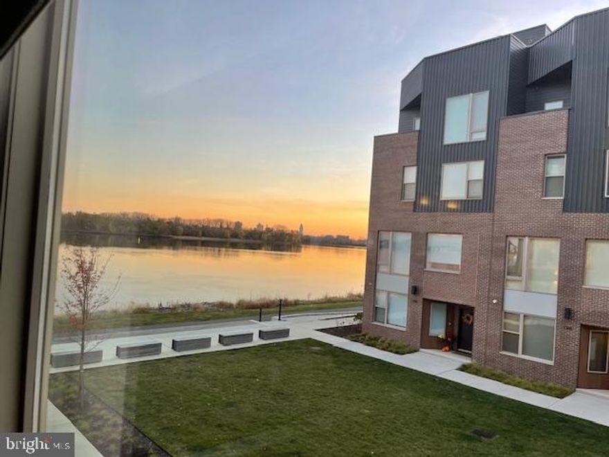 Stunning river views! Fully loaded! Welcome to the stunning 5 story elevator townhouse, nestled near the picturesque Delaware River at Northbank. This exceptional 4-bedroom, 3 full, 2 ½ -bathroom, 2 car garage, elevator townhome boasts a remarkable blend of elegance, comfort, and waterfront living.
As you step inside, you'll be greeted by a bright and airy open floor plan, adorned with large windows that allow natural light to flood the space. The first floor has an abundant office space, ½ bath, equipment closet, coat closet and 2 car garage access. 
The second level features a spacious living room with 10’ ceilings, 8’ windows, perfect for entertaining guests or relaxing with family. The gourmet kitchen is a chef's dream, equipped with high-end stainless steel appliances, including 36” Wolf range, Sub Zero refrigerator, quartz countertops, and ample cabinet space. Dining area with a dry bar, including wine cooler and a ½ bath.  
The three additional bedrooms provide plenty of space for family members or guests, each with its own unique charm. Two bedrooms share a hall bath with tub and a third bedroom with a private ensuite bath with tile shower. Also, on this floor is the laundry room and mechanical closet. 
Make your way to the upper level, where you'll find a generously sized owners suite, a true sanctuary. Complete with a custom walk-in closet and a luxurious ensuite bathroom, featuring a soaking tub, separate shower, and double vanity. The fourth floor also features a wet bar and open area with room for a living area, gym or office with a walkout balcony. 
Rooftop deck with Trex decking, outdoor lighting with views of the Delaware River from multiple vantage points, North to Graffiti Pier, South to the Ben Franklin Bridge and East across the Delaware River to Petty Island (a nature preserve). Imagine sipping your morning coffee while watching the boats sail by or enjoying a sunset dinner with loved ones. The tranquil surroundings create a serene atmosphere, perfect for unwinding after a long day.
Additional highlights of this exceptional home includes a Brick front, Pella windows, Energy Star certification, 2 zone HVAC, Smart home wiring, a convenient laundry room, and an oversized two-car garage for your vehicles and storage needs. The Northbank community offers an array of amenities, including several parks and walking trails, providing endless opportunities for relaxation and recreation.
Located in close proximity to shops, restaurants, and major highways, this home offers the perfect balance between a peaceful riverside retreat and easy access to modern conveniences. Don't miss the opportunity to experience waterfront living at its finest in this exquisite townhome.
