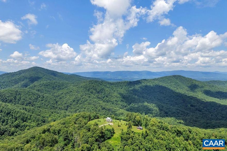 This is a remarkable mountaintop estate of 377 acres, featuring a stunning six-year-old cabin with one-of-a-kind views, a timber-frame cottage made from 200-year-old materials, a pond, a campsite, trails, and incredible tracts of untouched forest. The four-bedroom residence (2,697 sf), with high-end materials that are built to last (metal roof, copper gutters, fiber cement siding, pine paneling, stone fireplaces, slate, hardwood, and concrete flooring, etc.), is as impressive as its surroundings. It is also understated, simplistic in its design and practical and efficient in its layout. The bluestone veranda, with dramatic views to the north and west, steals the show. Located 20 minutes south of Charlottesville, this completely private retreat consists of four contiguous parcels. The second (212.19 ac.), known as "Dancing Creek," includes the three-bedroom timber-frame cottage, large garage, trails, streams, and more. The third (31.69 ac.) includes a log cabin, suitable for guests or a property manager. The fourth (21.04 ac.) is unimproved. The entire offering includes miles of walking and riding trails, is made up primarily of hardwood forests, and is surrounded by thousands of acres of farms and estates.,Wood Cabinets,Fireplace in Great Room,Fireplace in Master Bedroom