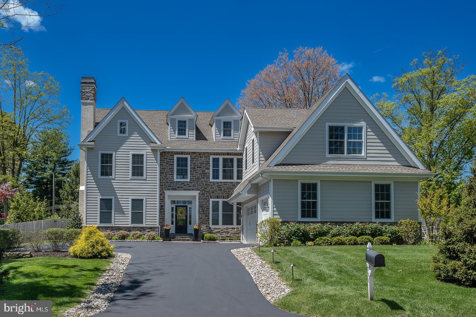 Welcome to this beautifully appointed and meticulously maintained better than new custom home located in the highly desirable community of Wayne, PA. It has everything a discriminating buyer is looking for complete with front-to-back reception Foyer, large bright rooms, exquisite details, hardwood floors, recessed lighting throughout and gorgeous views.
This spacious and sophisticated property features 5 Bedrooms, 4 Full Bathrooms, 2 Powder Rooms, a finished Loft, outdoor Lanai and a three-car attached Garage, all situated on a beautifully landscaped ¾ acre lot. The front to back Reception Foyer, with 9 ft. high ceilings, contemporary chandelier, gleaming hardwood floors, custom millwork, turned staircase and cased openings to the Formal Living and Dining Rooms, tastefully sets the stage for the remainder of the home. The stylish Formal Living Room features a beautiful gas fireplace with marble surround, has ample natural light and together with the elegant Dining Room is the perfect space for entertaining guests. The convenient first floor Office/Den is perfect for those who work from home, has dual French doors for privacy, views of the rear yard and access to the adjacent Powder Room.
Heading into the ‘heart of the home’ is the gorgeous Gourmet Kitchen, ideal for the most discerning chef, with custom white wood cabinetry, gorgeous Carrara marble countertops & backsplash, undercounter lighting, and top of the line stainless steel appliances. The oversized center island features ample counter space, a custom sink with ‘on demand’ hot & cold filtered water, stylish light fixtures, and seating for four. There are side counters for more prep space and a walk-in Pantry for storage. The bright Breakfast/Morning Room has additional counter space and is the perfect setting for your morning meal. The inviting Family Room, located just off the Kitchen, features a gas fireplace, coffered ceiling, tall windows and dual glass doors leading to the Lanai. The first floor is further enhanced by a handy Mudroom complete with hooks, bench & closet for storage, a Powder Room, side door to the driveway, and interior access to the Garage.
Upstairs, the Primary Bedroom is a true retreat, featuring a large sitting area, vaulted ceiling, two walk-in closets, and a luxurious en-suite Bathroom with dual sink vanity, a soaking tub, and a separate shower. There are four additional spacious bedrooms on this level, two with ensuite Bathrooms all with ample closet space and access to another full Hall Bathroom, as well as a convenient Laundry Room.
Heading up another level is a substantial finished Loft, offering a wonderful, expanded living area, media/game room, and/or playroom complete with large walk-in storage closets the possibilities are endless for this space.
The lower level of the home features an enormous unfinished Basement, a perfect place for an additional Family Room, home theater, exercise room, wine cellar, and more. Comfort and convenience are yours with an automatic generator by Generac that powers the whole house in the event of a power outage.
The rear exterior of this home is a private oasis, complete with an expansive Lanai with gas bluestone fireplace, remote controlled full height retractable screen openings, ceiling fan, & recessed lighting. The entire property is beautifully landscaped with a thoughtful selection of plants, trees for privacy and complementary shrubbery. The lush green lawn and spacious wet laid bluestone patio area are perfect for summer barbecues, outdoor gatherings, entertainment, or for just family relaxation. There is a Basketball Court that can be converted into a Pickleball court for the outdoor enthusiast.
Located in the highly sought-after T/E School District, this home is just minutes from the charming boutiques, restaurants, and entertainment options of downtown Wayne. With its beautiful architecture, luxurious finishes, and prime location, this home is truly a must-see!