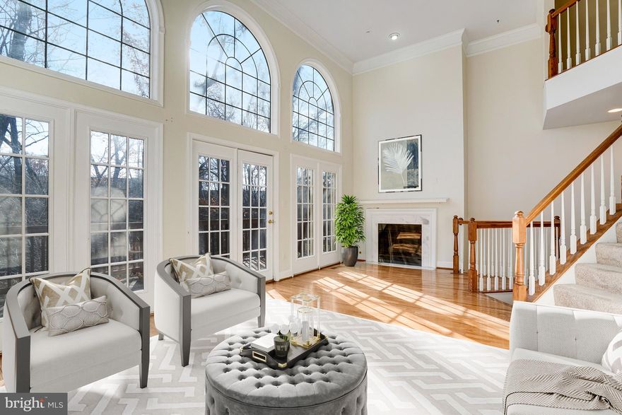 Large, stately brick townhouse located in the sought-after Stonegate community of Alexandria. This sophisticated 3-bedroom, 2 Full/2Half-bath home offers four levels of well-designed living space filled with natural light. The main level features hardwood floors, classic moldings, a gas fireplace, and a dramatic living room with cathedral ceilings and a wall of windows overlooking mature trees and a peaceful setting. The gourmet kitchen includes gas cooking, granite counters, stainless steel appliances, a breakfast bar, and an eat-in area. ideal for everyday living and entertaining. The spacious primary suite offers vaulted ceilings, a walk-in closet, and a spa-style bath. The lower level includes a generous rec/family room with a second gas fireplace, full bath, and flexible space perfect for a home office, gym, or guest area. Additional highlights include two rear decks, a private patio, a two-car garage, and easy access to I-395, Shirlington, Old Town Alexandria, and DC. A rare opportunity combining space, setting, and convenience.