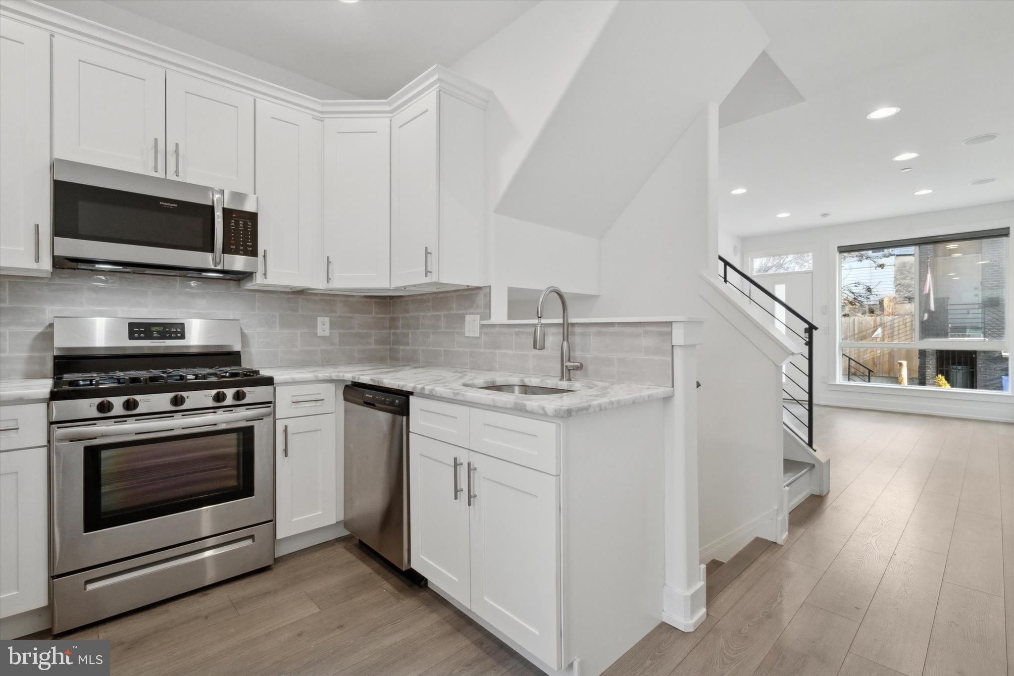 Clean, simple, bright. A savvy purchase for homeowners and investors alike! This 3 bed (could be 4!), 3 full bath, 4 years young new construction offers 6 years on the tax abatement, custom motorized window treatments, a double roof deck, energy efficient appliances, and so much more! It is a blank canvas, waiting for your personal style. As you enter, you will be greeted by endless natural light through the almost floor-to-ceiling oversized front window, located on every floor, which can be toned down by the remote controlled motorized custom window treatments. The open living and dining area, with versatile luxury plank vinyl flooring and a coat closet, is divided from the kitchen by the U shaped staircase. The kitchen is adorned with all stainless appliances, abundant white shaker cabinetry, granite countertops, and a clean subway tile backsplash. Out back is a modest fenced in patio, large enough for a grill and friends. Downstairs in the finished lower level, you will find the first full bath, den area, stackable washer and dryer, and mechanical room with the pex manifold, tankless hot water heater, high efficiency HVAC, and sump pump. This could be used as the 4th bedroom, a tv room, gym, office, whatever! Upstairs on the 2nd floor are two bedrooms drenched with sun, each with custom window treatments, large closets and a full bath with a tub. The third floor features the primary suite with a gleaming oversized window, enough space for a king sized bed, motorized custom window treatments, illuminated tray ceilings and a walk-in closet, wet bar, and a full bathroom with a double vanity and double shower heads. Finally, there are TWO roof decks, front and back, to always ensure a sunny or shady spot. The home also features a technology package including an in-home security system, as well as built in speakers, receiver, and hidden cable management for your entertainment systems. Located walking distance to both Fishtown and Temple University, just off the ever-growing American Street, within a short walk to the Berks MFL train line, plenty of bus routes, one block to two grocery stores - this location can’t be beat. Also a short stroll to hot spots like Stateside, Wissahickon Brewing, Starbolt, Nextfab, LMNO, Kalaya, Rowhome Coffee, Provenance, Keystone Bike CO, Human Robot, Luna Cafe, etc., and all the new hustle and bustle at Front & Berks! Perfect for student housing (3 full baths!), or an owner occupant looking to make a smart investment. This is a great opportunity to get into a new construction home at an affordable price!