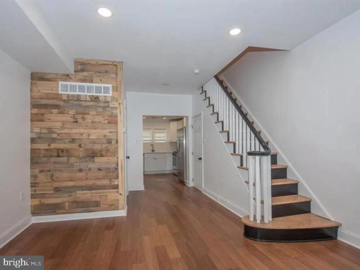 Tucked into a tranquil South Philadelphia block, this charming 2‑bed, 1.5‑bath straight‑through row home is the perfect blend of historic character and modern style. From the moment you arrive, a bright blue front door sets the tone, this is no cookie‑cutter rehab. The main level has an inviting open floor plan with high ceilings and recessed lighting, a custom powder room and a sleek modern kitchen featuring stainless‑steel appliances, chic black fixtures, recessed lighting, and a cozy built‑in dining nook. Upstairs there are two spacious bedrooms, each offering generous closet space and a beautifully updated full bath with classic subway‑tile shower and eye‑catching custom tile flooring. There is a fully finished lower level with laundry area with the washer and dryer included and abundant storage space. This cozy home is in a walkable, vibrant neighborhood close to parks, transit, and city‑center conveniences. Move right in or invest in a turnkey, stylish city home that’s already built for modern living.