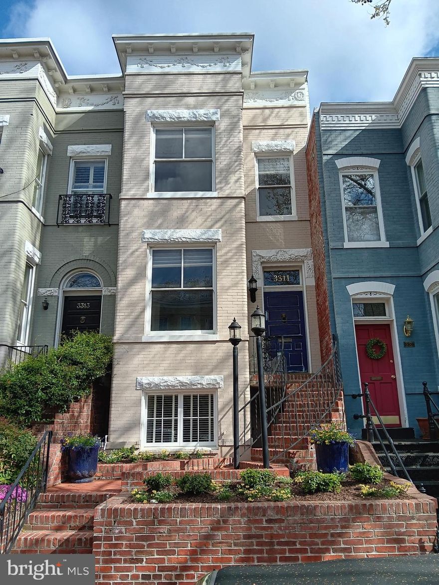 Prepare to be awestruck by a masterpiece; this is effectively a new home with the very highest end custom finishes throughout. Absolutely nothing was spared and no detail overlooked in this stylish and meticulously executed project. Please see attached document with exhaustive list of improvements. Not a flip or spec - improvements were done for a young family in anticipation of a house-for-life. 4BR/3.5.5BA 3-level Georgetown Victorian rowhouse, including separate 1-bedroom apartment in lower level. You are welcomed to the home by charming, curved outdoor steps and a restored vintage front door with antique knocker. 10'+ ceilings on main level. Lovely hickory hardwood floors, recessed lighting and elegant molding throughout. Living room boasts extensive built-in shelving and rebuilt Bellfire wood-burning fireplace. Custom kitchen features built-in plumbed Miele coffee maker, Miele speed cook, Miele dishwasher, Sub-Zero fridge and beverage fridge. Stylish marble floors and marble countertops. Wolf gas range with double oven has 4 burners plus griddle and charbroil elements. Ample storage in tall, extensive custom-built kitchen cabinetry.  Easy access to a superior, spacious back yard which features custom cedar pergola, new ceiling fan, new Lynx gas heater and built-in 36" gas grill (piped for gas). Stroll on custom pavers to a sunken seating area with built-in gas fireplace.  Bedroom level boasts 9'+ ceilings and hickory hardwoods. Primary suite includes box bay window (large windows), custom built-in drawers, ceiling fan and mounted TV (conveys). Primary bath has Kohler fixtures, double vanity, Calcutta mint marble tiles and soapstone counters. Stacked Miele laundry unit with ample storage in hall closet. Hall bath has Carrera marble and tile accent line, oversized tub and generous soapstone surround. 2nd and 3rd bedroom are both good-sized with ceiling fans. Mounted TV in 3rd bedroom conveys. Fully finished lower level has been completely renovated and was dug out to create 8'+ ceilings. It is currently separated from the main house with separate gas and electric connections. Can easily be reincorporated with drop-down stairs from side of main level dining room. Radiant heat throughout supplements heat provided by two mini-splits and gas fireplace. Modern kitchen boasts Viking and Miele appliances, large pantry and breakfast bar. 1.5 bathrooms each have travertine tile and Kohler fixtures. Bedroom has ceiling fan, mounted TV (conveys) and oversized walk-in closet. Full size stacked laundry. And don't forget a very useful attic space with carpeted floors for storage, leading to a roof hatch that brings you to the rubber roof boasting monument views. Superior, modern infrastructure: solar panels on roof have earned over $24,000 in Solar Renewable Energy Certificate (SREC) payments since installation. Electric, plumbing and gas lines completely upgraded. New water and sewer lines connected to main line. Both main house and lower level have Pelican whole house water filtration systems. Rinnai tankless water heater in main house. New Mitsubishi HVAC system. In-ceiling speakers throughout main and bedroom levels. Unbeatable location: on a delightful, tree-lined one-way street one block from Volta Park and just over a block from Wisconsin Ave. You will be hard-pressed to find a Georgetown home as flawless as this magnificent abode.