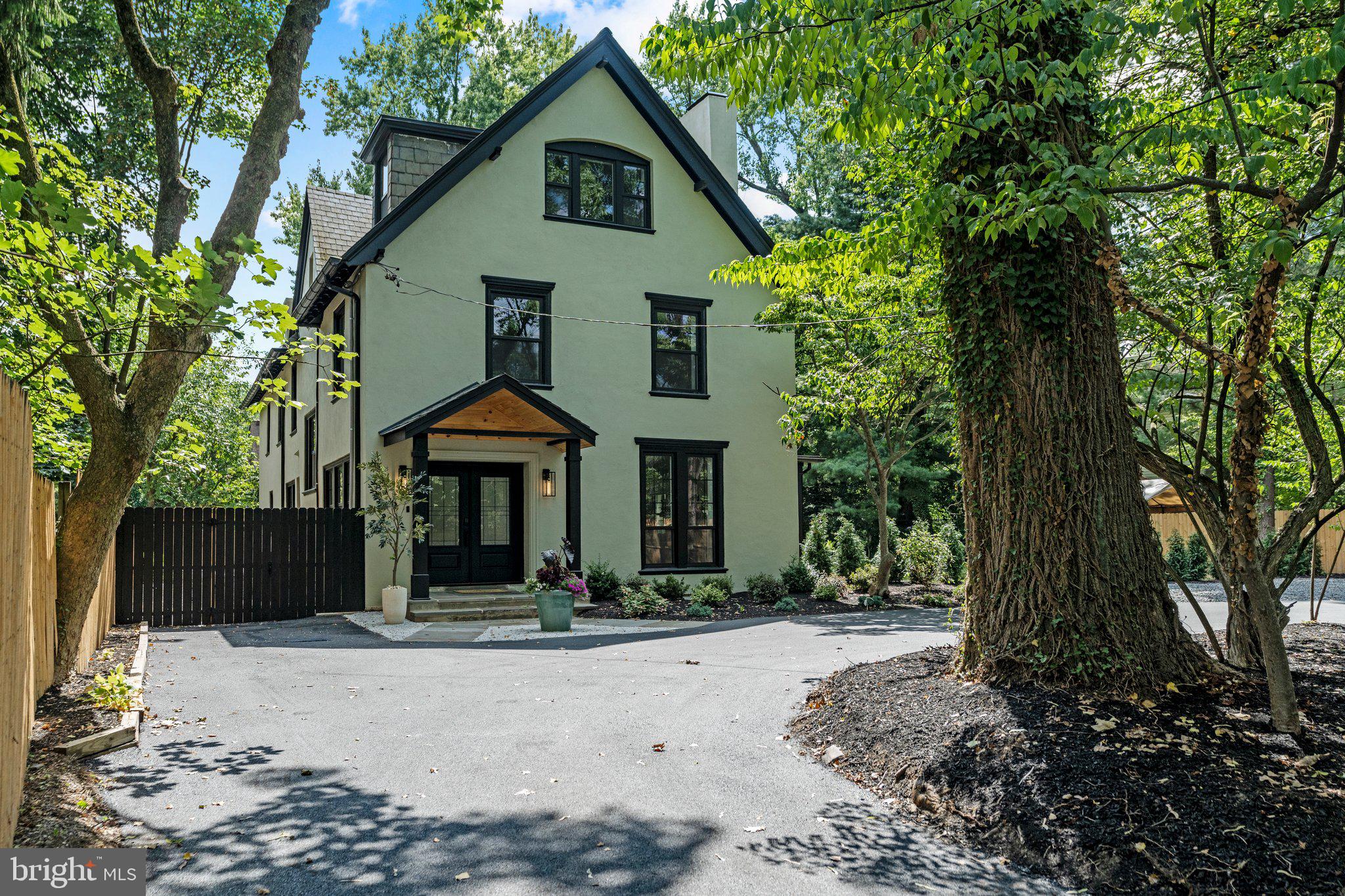 Unique and Rare residence in the heart of historic and vibrant Chestnut Hill, 8512 Stenton Ave, is the Dream Home you’ve always wanted. Do you believe in love at first sight? If not, you will the second that you pull into the brand new circular widened driveway surrounded by a verdant, manicured landscape and step foot on this absolutely breathtaking property estate, situated in Philadelphia most desirable neighborhood. The home presents a truly distinctive living experience offering an enchanting blend of modern living and classic charm. This 5 bedrooms and 3.5 bathrooms home has been masterfully reimagined with top finishes and artfully curated with an inviting layout. Step inside and discover an ambiance of refined elegance, where every detail has been thoughtfully considered. Hardwood flooring and recessed lighting throughout the entire residence. Upon entering through the gorgeous French doors you will be greeted by a spacious foyer with lots of natural lighting continuing onto an open floor plan that seamlessly integrates the living spaces, creating an inviting and spacious atmosphere. Expansive living room with floor to ceiling windows, gorgeous fireplace, side entry doors leading to a private tiled patio with roof enclosure that is a perfect setting for a family and friends gatherings. The heart of the home is the beautifully upgraded Gourmet & Upscale kitchen designed with YOU in mind. It’s a culinary haven featuring abundance of windows, counter space and custom cabinetry including top-of-the-line appliances, pot filler, hot water dispenser, touchless faucet, country sink with food disposal, wine cooler, premium countertops and backsplashes. There is also a back entry door of off kitchen leading to a secondary private newly finished fabulous outdoor space ideal for play and entertainment. First floor powder room for convenience. Ascend the new and wide staircase with windows at landings. Stepping to the second floor sleeping level you will find a luxurious Master suite. This sanctuary boasts a large bedroom, roomy walk-in closet with window and an exquisite en-suite bath showcasing high-end fixtures, exquisite tiling, free standing tub, abundance of natural light, enormous walk-in shower with 84” high frameless glass enclosure with door and a spa-like ambiance that promises relaxation. On same level you will find 2 spacious bedrooms with ceiling fans and generous-size closets, full Hall Bath with contemporary double vanity and mirrors, elegant lighting, full tub, toilet, a large window & designer’s pattern tiled walls and floor. You will also find a fully equipped laundry room with stackable washer and dryer and plenty of cabinet space with quartz counter tops. Ascend once more onto a third floor sleeping level to find 2 generous sized bedrooms, different by layout, but identical in their charm. Both rooms are graced with plenty of closet space and windows with natural light. There is also hvac room & a full hall bath, offering large step-in shower, refined tiling, a toilet, vanity with mirror & a window. One of the property's crowning jewels is the backyard oasis with freshly manicured landscaping designed for ultimate relaxation and entertainment. Full basement with back entry bilco door is a great addition for extra storage. Plus, enjoy the peace of mind of a one year home warranty. The exterior offers charming facade with stucco finishing, providing a timeless and elegant look. Large circular driveway, plenty of parking space and a side yard for extra needs. Located in historic Chestnut Hill just a short walk from the neighborhood's charming shops, restaurants & cafes on Germantown Ave. This is an exceptional opportunity to own such an elegant piece that exudes elegance and boasts a multitude of stunning upgrades of one of Philadelphia's most desirable neighborhoods. Make it yours and embrace this epitome of modern living.