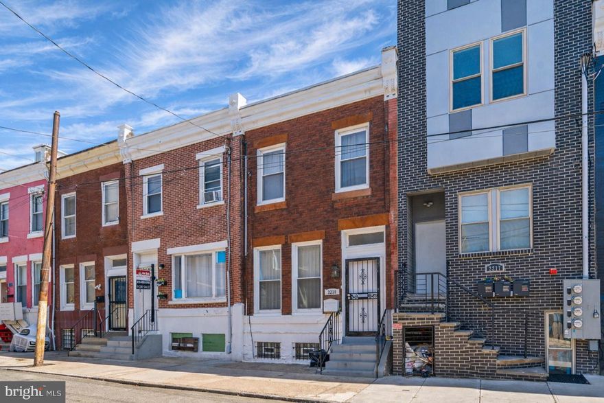 Beautifully renovated, meticulously maintained, located on a nicely developed block just steps from Temple University. Comfortable living room with oak flooring and decorative fireplace. Expansive eat-in kitchen with oak cabinetry, granite countertops, newer appliances, main-floor stackable washer and dryer. Generous main-floor bedroom and full bath, deal for guest suite, home office, or flexible living. Exceptionally deep outdoor space extending nearly 100 feet. Updated hall bath with floor-to-ceiling ceramic tile, walk-in shower, excellent closet space. Major systems updated in 2008 including electric, plumbing, central HVAC, and windows. Clean, well cared for, move-in ready. Shows beautifully!