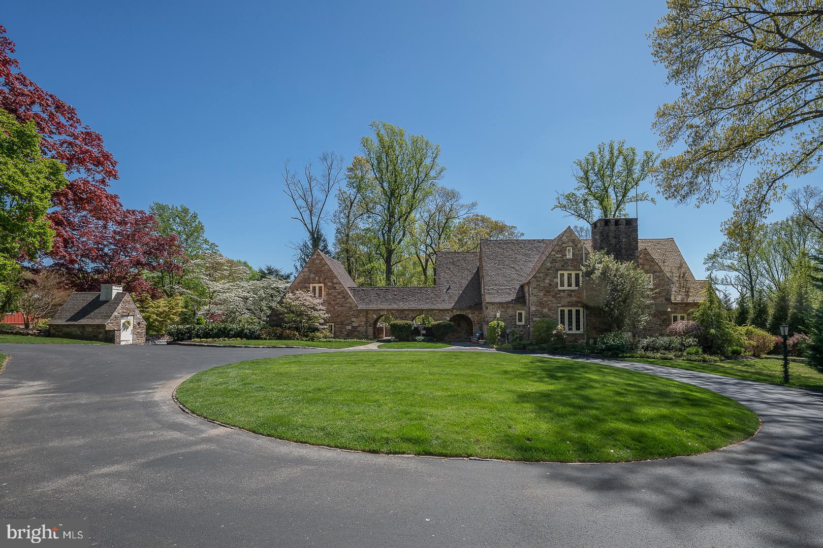Welcome to this breathtaking Norman English Estate designed by renowned architect Grant M. Simon situated on just over 1.5 acres in the award winning Rose Tree-Media school district. This home has been thoughtfully renovated to update the space while keeping its original old world charm. As you find your way from the cul de sac to the home you will arrive at the large circular driveway giving a grand feeling of what is to come. This stunning stone home has a portico/breezeway that connects the main house to the in law/au pair suite & garage. Walk into the home and find an updated and freshly painted Kitchen with quartz counters and island, farmhouse sink, wine fridge, stainless steel appliances and a beautiful dutch door leading to the outdoor Kitchen area. The Dining Room is large and bright with doors to the fieldstone patio with built in fire pit. The spacious Great Room has gorgeous woodwork, original stone, built in cabinetry around the TV, gas fireplace and an extra reading nook area. From the Great Room you will enter the amazing Sun Room with stone floors and walls – a great place for dining with spectacular views and access to the patio fire pit area. We can’t forget to mention the large Study with leather studded walls and gas fireplace – a perfect place to work from home! A mud room and powder room complete this main floor. Upstairs you will find hardwood flooring in all the bedrooms. The Main Bedroom en suite has a large walk in closet, another closet with barn doors and a newly built bath with free standing tub, shower, double sink vanity, private water closet. There are 3 additional Bedrooms and a full hall bath with new custom cabinets, glass block wall, double sink vanity and new faucets. The lower level is finished – you will enjoy a spacious Family Room with gas fireplace, wine cellar, large pantry, fabulous laundry room and a powder room. Over the 2 car Garage you will find a perfect in law/au pair suite complete with a Bedroom, updated Bath and large closet. Outdoors there are so many opportunities to enjoy the space - watch amazing sunsets from the fieldstone patios, swim in the 20' x 40' saltwater pool, cook in the outdoor kitchen or pizza oven area with herb garden, relax by the pond or play your favorite games on the soccer field like yard. The grounds of this estate are incredible with fieldstone walls and walkways, specimen trees, shrubs & flowers. While on public water and sewer, the well house is still in use for gardening and filling up the pool! Inside you will find character & craftsmanship, period details, handcrafted woodwork & moldings, limestone archways & walls. Outside you will find peace and tranquility! Enjoy this magnificent estate setting and still be walkable to downtown Media! A perfect place to call home!