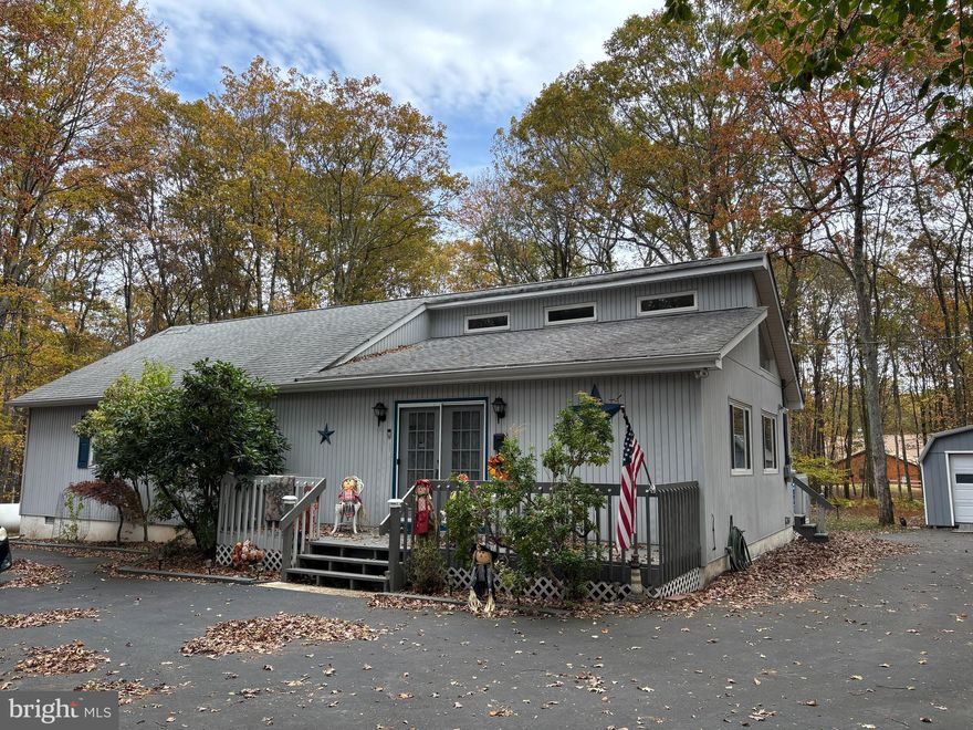 Don't miss on this very well kept 3 bedrooms, 2 baths ranch sitting on one acre of land in the private part of Towamensing Trails community called Deer Park. House offers cathedral ceilings, open floor plan, a lot of natural light, living room floating into a dining room area with access to kitchen and oversized deck. Kitchen features stainless steel appliances, kitchen island and plenty of counter top space. Primary bedroom has its own bathroom. There is a partially finished attic space accessible through pull down steps which gives a lot of storage space. Additional features are one car garage with metal roof, shed and paved driveway. Community with many amenities is allowing STR.