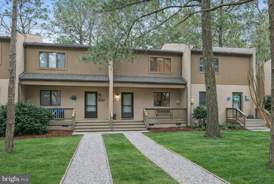 Welcome to this inviting two-story contemporary villa nestled in the well located coastal community of Villas of Bethany West, just minutes from the sandy shores of Bethany Beach. Being sold furnished and turnkey, this home is ready for immediate enjoyment as a beach getaway, full-time residence, or rental investment.

The first floor offers a bright and functional layout designed for easy coastal living. The kitchen features LVP flooring, ample workspace, and a convenient pass-through to the living area, creating an open and connected feel. There is also space for a cozy table and chair set, perfect for casual meals. A washer and dryer are thoughtfully tucked away for added convenience.

The dining area flows seamlessly into the living room, where a large sliding glass door fills the space with natural light and leads to the rear patio. This outdoor space is ideal for grilling, dining al fresco, or simply relaxing while enjoying tranquil views of the nearby pond and surrounding nature. The living room is warm and welcoming creating the perfect setting for cozy evenings. Additional storage can be found beneath the stairs, adding practicality to the space.

Upstairs, you will find two comfortable bedrooms, including a guest bedroom with peaceful views of the pond. The primary suite features its own private bath, while a full hall bath serves the additional bedroom.

After a day at the beach, rinse off in the convenient outdoor shower located on the rear patio, a perfect coastal touch.

Residents of Villas of Bethany West enjoy a variety of amenities, including a playground, in-ground swimming pool, tennis courts, as well as acres of natural surroundings. With its close proximity to Bethany Beach, local shops, and dining, this home offers an ideal opportunity for a beach getaway, full-time residence, or a lucrative rental investment.
(Front  Exterior Photo has been digitally enhanced for presentation purposes)