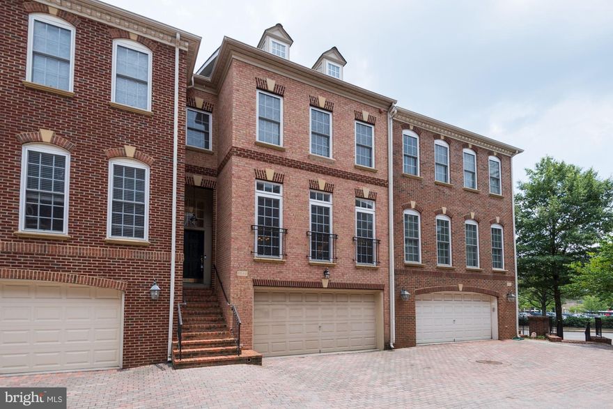 Stroll to EFC Metro  4 level brick TH w/2 car garage & 3 BRs & 2 baths up & top floor loft/4th BR.  LL rec room w/fpl & doors to fenced yard; kitchen w/wood cabs, granite tops, s/s appls opens to family room & deck. High ceilings, wood floors main; new carpet, fresh paint, pristine cond.  Walk to parks, bikepath, between Westover & Lee Harrison. Tuckahoe Swanson Yorktown