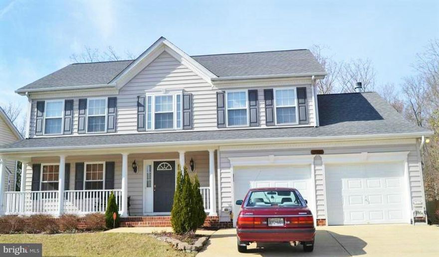 Beautiful 4 bedroom 2 1/2 bath house that backs up to trees in a great location.  Hardwood floors on the main level, neutral colors through out.  Huge kitchen with natural light that opens to family room on one side and the dining room on the other.  House is priced to sell.  its warm and welcoming! Unfinished basement that has a walk out as well.  2 car garage that opens to mud room and laundry