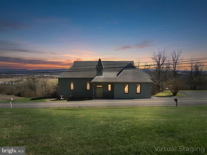 Perched above Bellefonte with commanding views of the surrounding valley, 1070 Valley View Road offers a rare blend of architectural character and modern functionality. Originally built in1905 as a church, this thoughtfully converted structure now serves as a 2-bedroom, 2-bath residence with 3,488 square feet of livable space, Set on .28 acres, the elevated location provides a constant visual connection to the landscape below changing with the seasons, beautiful sunsets and bringing a sense of openness and perspective to everyday life. The property’s vantage point enhances privacy while still remaining connected to the Bellefonte community. The fully finished main level expands the home’s versatility and comfort. This level includes two bedrooms, one full bathroom, laundry facilities, and additional finished living space, providing privacy and separation from the main lower-level area. It functions well for daily living, guest accommodations, or multi-use needs while maintaining a cohesive flow throughout the home. The home’s lower level is defined by its generous scale and adaptability. This open, light-filled space supports a variety of lifestyles and uses, whether envisioned as a serene yoga or wellness studio, a dance or creative studio, an event or gathering space, or simply an extraordinary living area that departs from conventional residential layouts. Also, have a full bath. Modern systems and upgrades have been completed with care, ensuring the home supports expectations while preserving its unique character. 2020 updates included bedrooms and closet improvements, electrical upgrades, hard wired smoke detectors, an escape window, full bathrooms on both levels, a comprehensive plumbing update with shutoffs for the kitchen, a UV water sanitation system, a water softener, a fresh interior paint scheme, installation of a power venter for the furnace, and all new doors and locks throughout the home. Between 2021 and 2022, Additional improvements included a new outdoor water spigot, a new hot water heater, mini-split heating and cooling systems installed upstairs, and added attic insulation for improved efficiency. In 2025, further enhancements were completed, including newly installed flooring in the main upstairs room, resurfacing and sealing of the basement concrete with new flooring added, and the addition of a patio with fireplace creating a welcoming outdoor space for relaxation or small gatherings. Also, included is one parking space. For buyers seeking a residence that offers more than square footage, one that delivers presence, flexibility, and a distinctive lifestyle, this Bellefonte property stands apart. It is a place where history and modern living intersect, offering room to live, create, host, and unwind all framed by sweeping valley views. Welcome to your new home.  Photos are virtually staged.